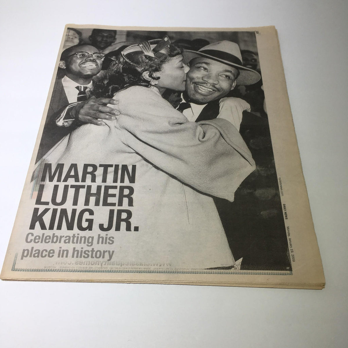 Vintage newspaper image featuring Martin Luther King Jr. embracing a woman, celebrating his place in history. Title: NY Daily News: Jan 19, 2009.