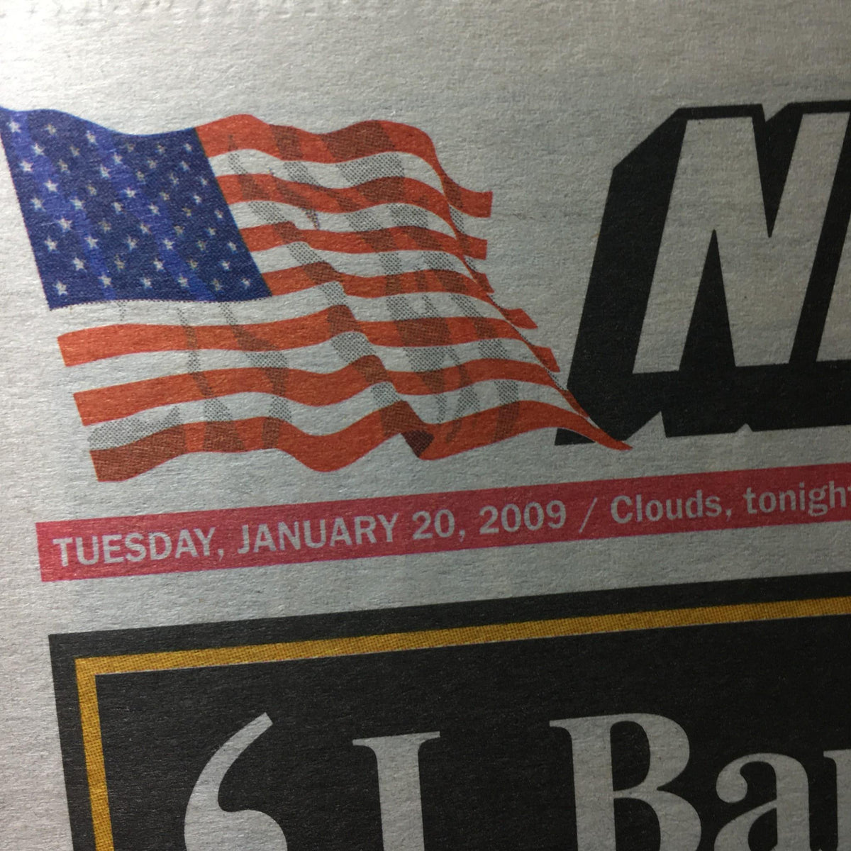 Close-up of the New York Post dated January 20, 2009, with an American flag graphic and date, highlighting the historic inauguration of Barack Hussein Obama.
