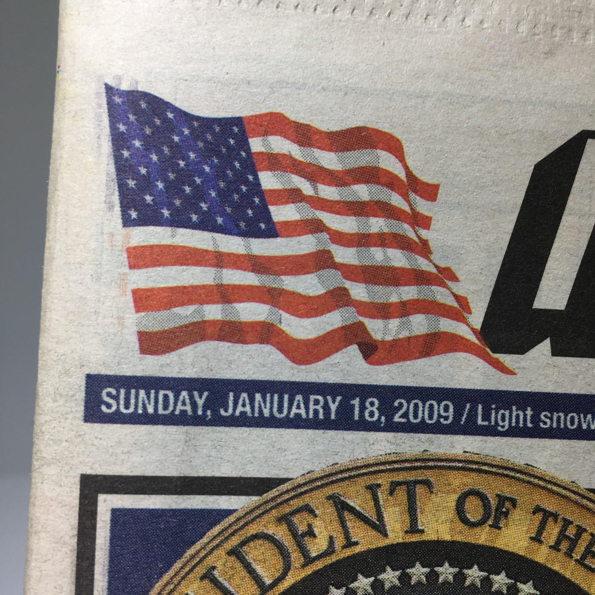 A close-up view of the NY Post dated January 18, 2009, displaying the American flag alongside the publication date, emphasizing the historical significance of the day.