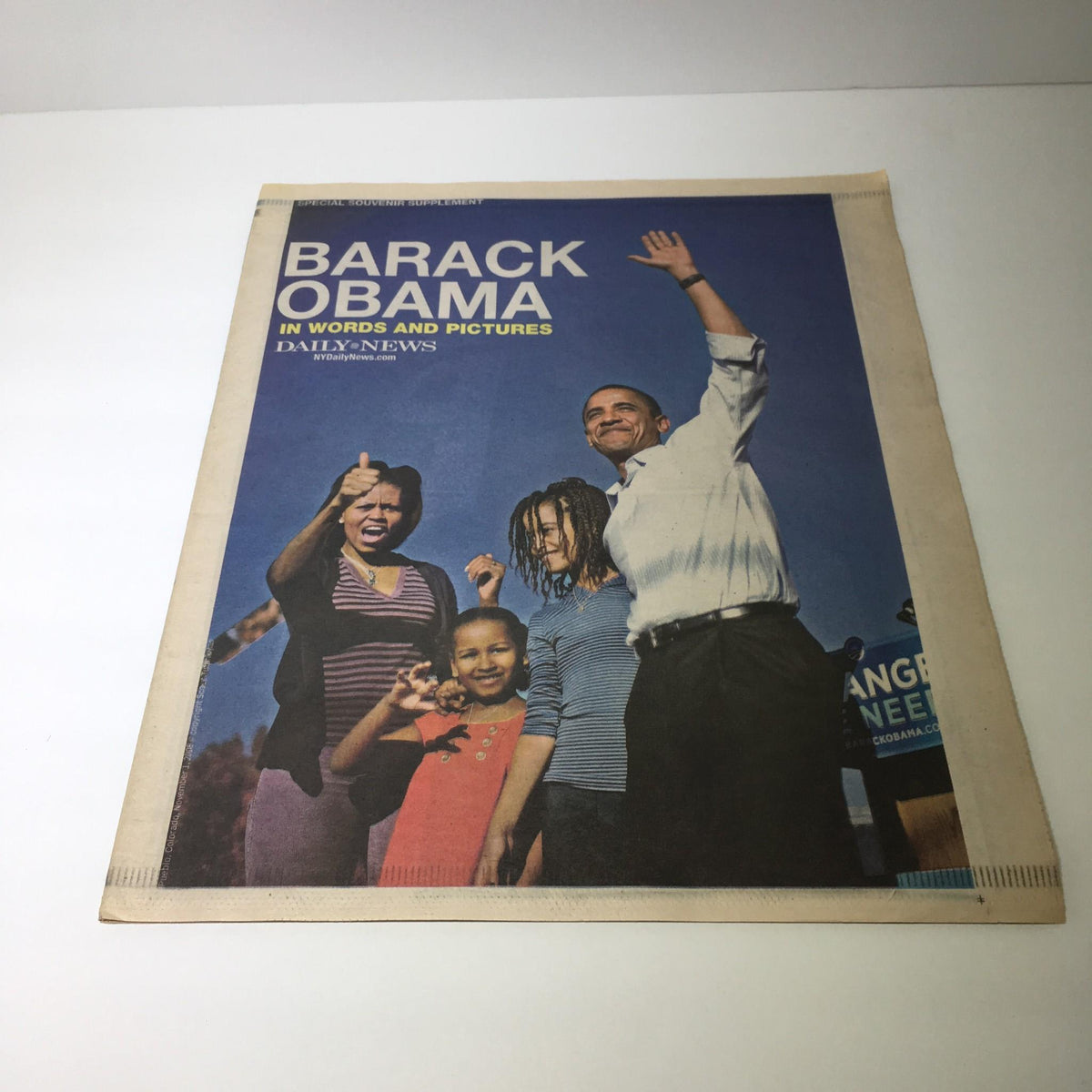NY Daily News cover from January 18, 2009, featuring Barack Obama smiling and waving with a group of people, highlighting a moment of celebration.