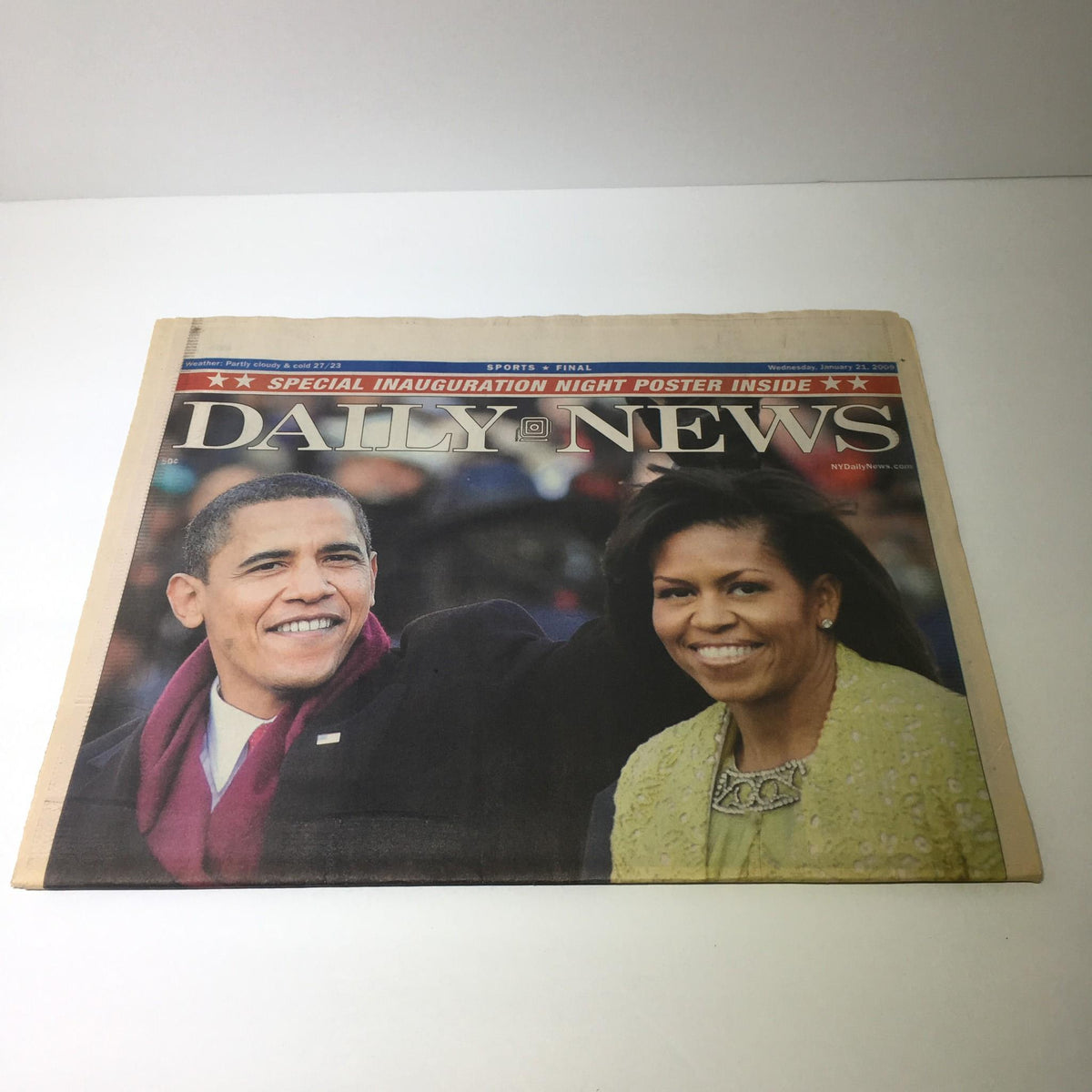 Close-up of NY Daily News from January 19, 2009 featuring Barack Obama and Michelle Obama, with the headline 'A Glorious Beginning', commemorating their historic inauguration.