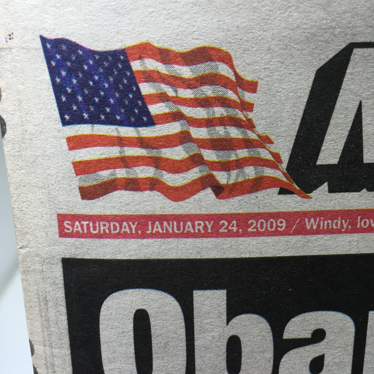 Close-up of the American flag and the date 'Saturday, January 24, 2009' from the New York Post, emphasizing the newspaper's release date associated with Obama's personal photos.