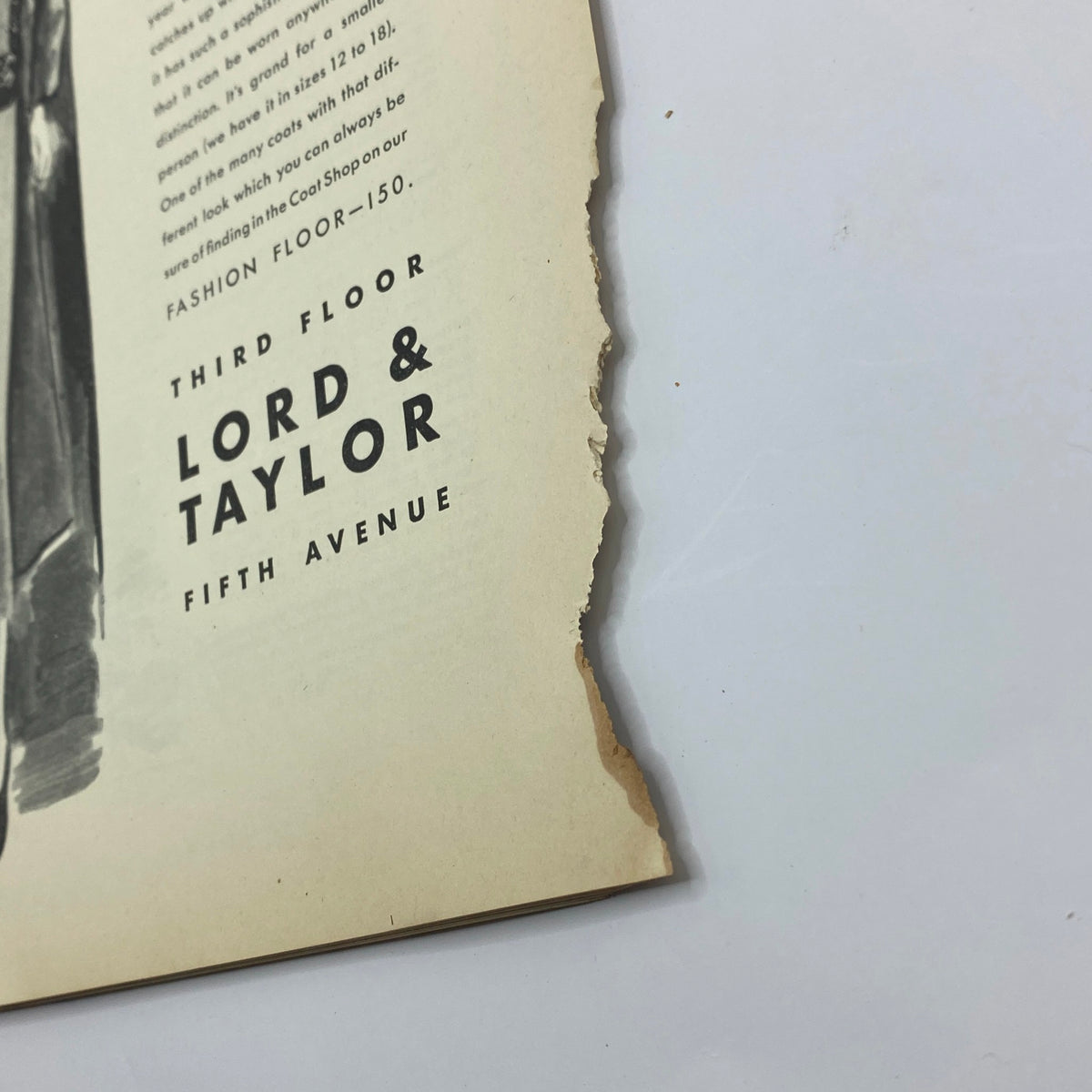 Detail view of the edges of a page featuring Lord & Taylor advertisement from The New Yorker Complete Magazine October 15, 1932 William Steig Cover, showcasing the worn condition.