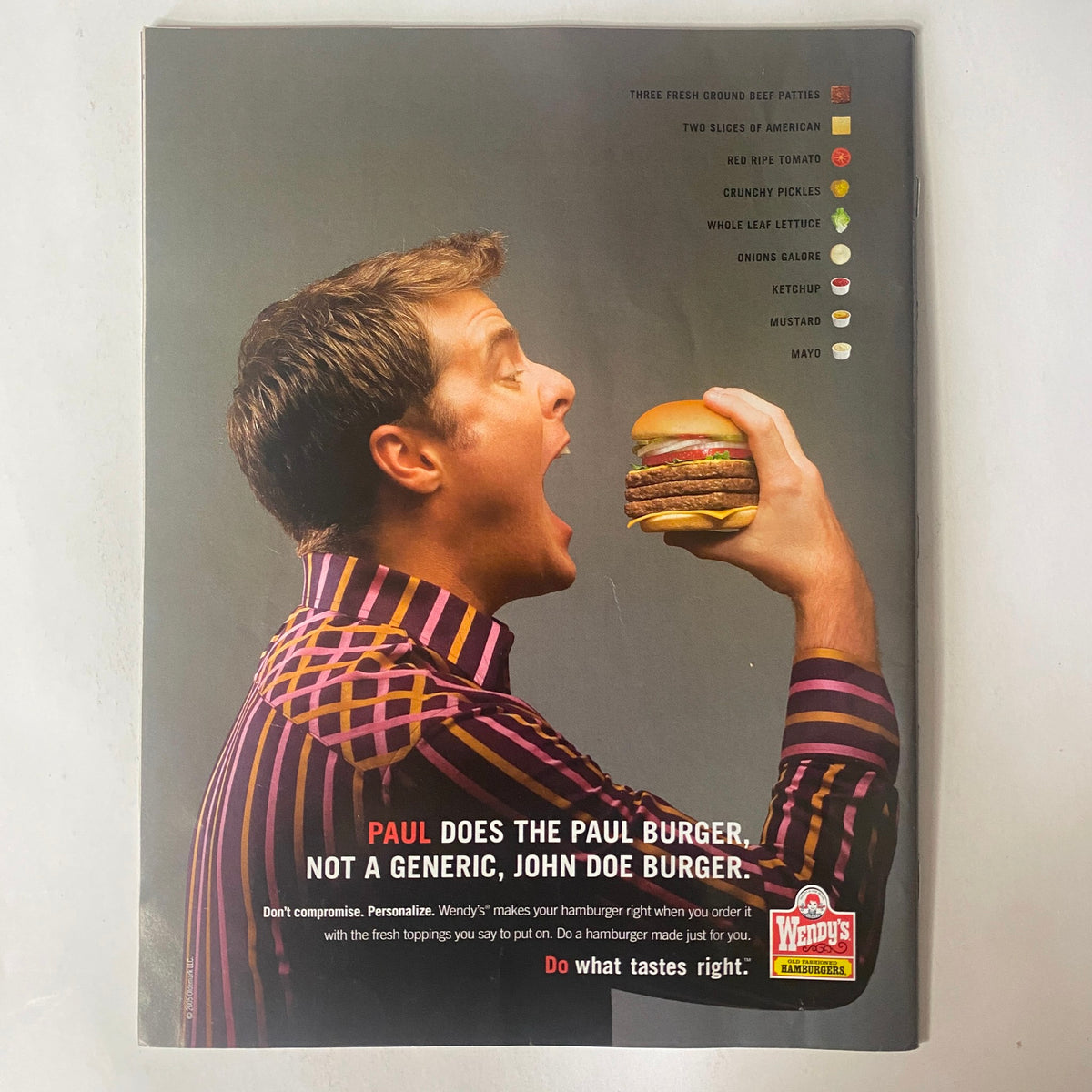 Back cover of Sports Illustrated Magazine October 17, 2005 showcasing an advertisement for Wendy's featuring a man enthusiastically holding a hamburger, emphasizing the brand's individuality.