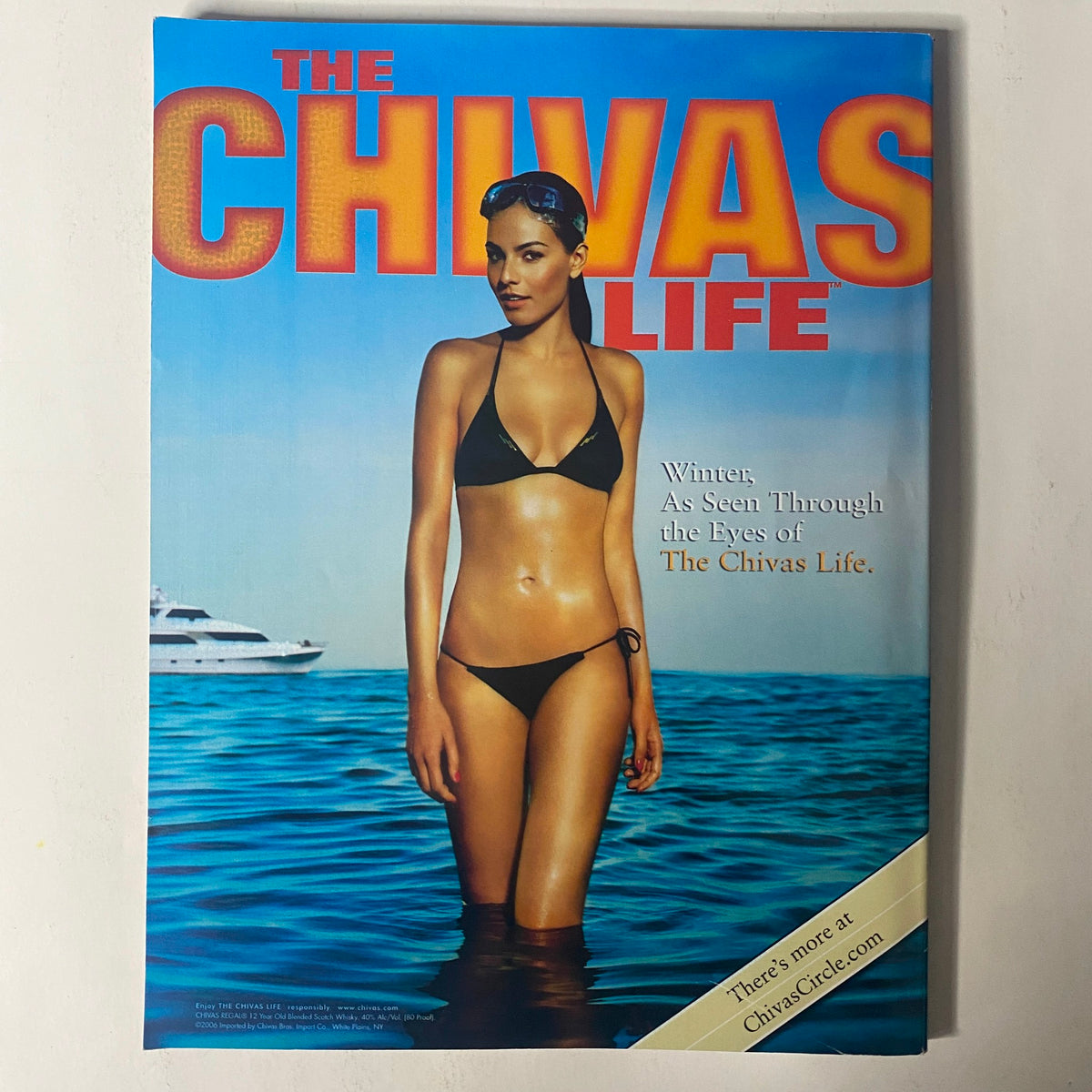 Cover of The Chivas Life magazine featuring a model in a bikini standing in water, emphasizing luxury and lifestyle associated with winter themes.