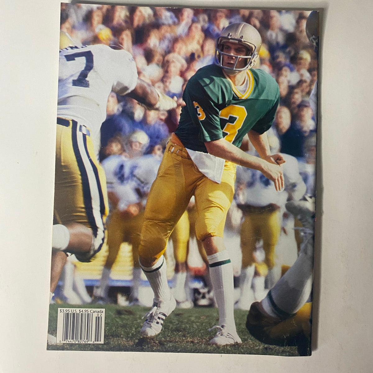 1993 Beckett Magazine Issue 2 Joe Montana San Francisco 49ers Tribute image depicting Joe Montana during his college days at Notre Dame, wearing a green and gold uniform.
