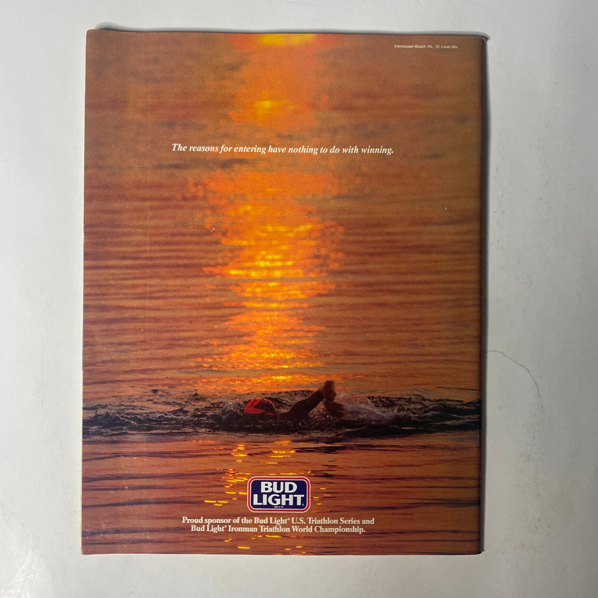Back cover of Triathlete Magazine October 1987 No. 50, featuring a serene sunset over water, promoting Bud Light's sponsorship of triathlon events.