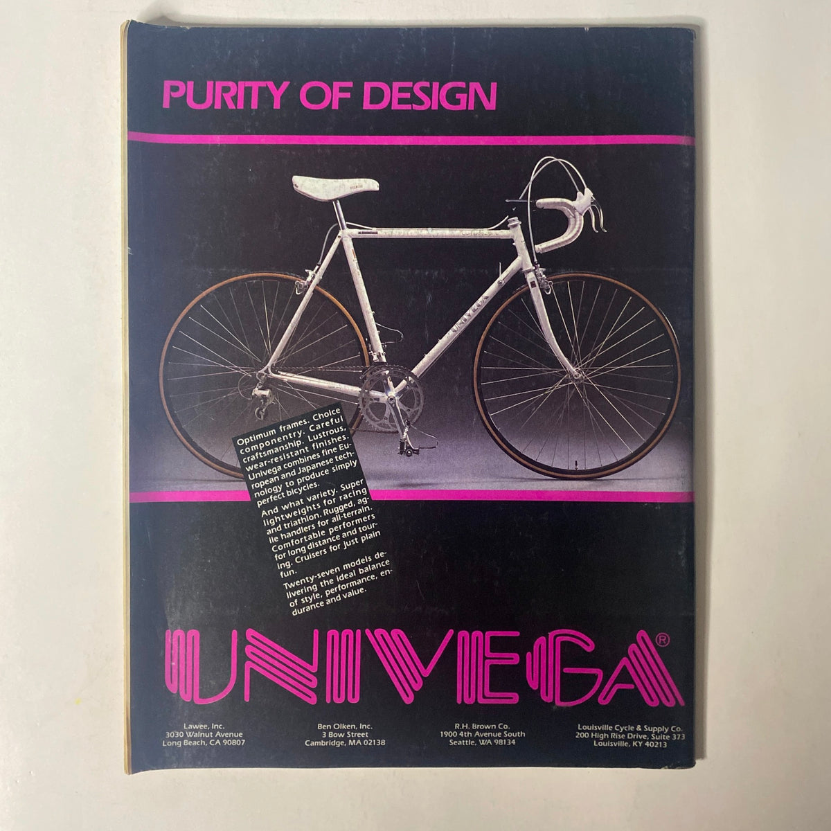 Back cover of Triathlon Magazine May 1986 showcasing a sleek white bicycle with the text 'Purity of Design' and the brand UNIVEGA, highlighting cycling equipment for triathletes.