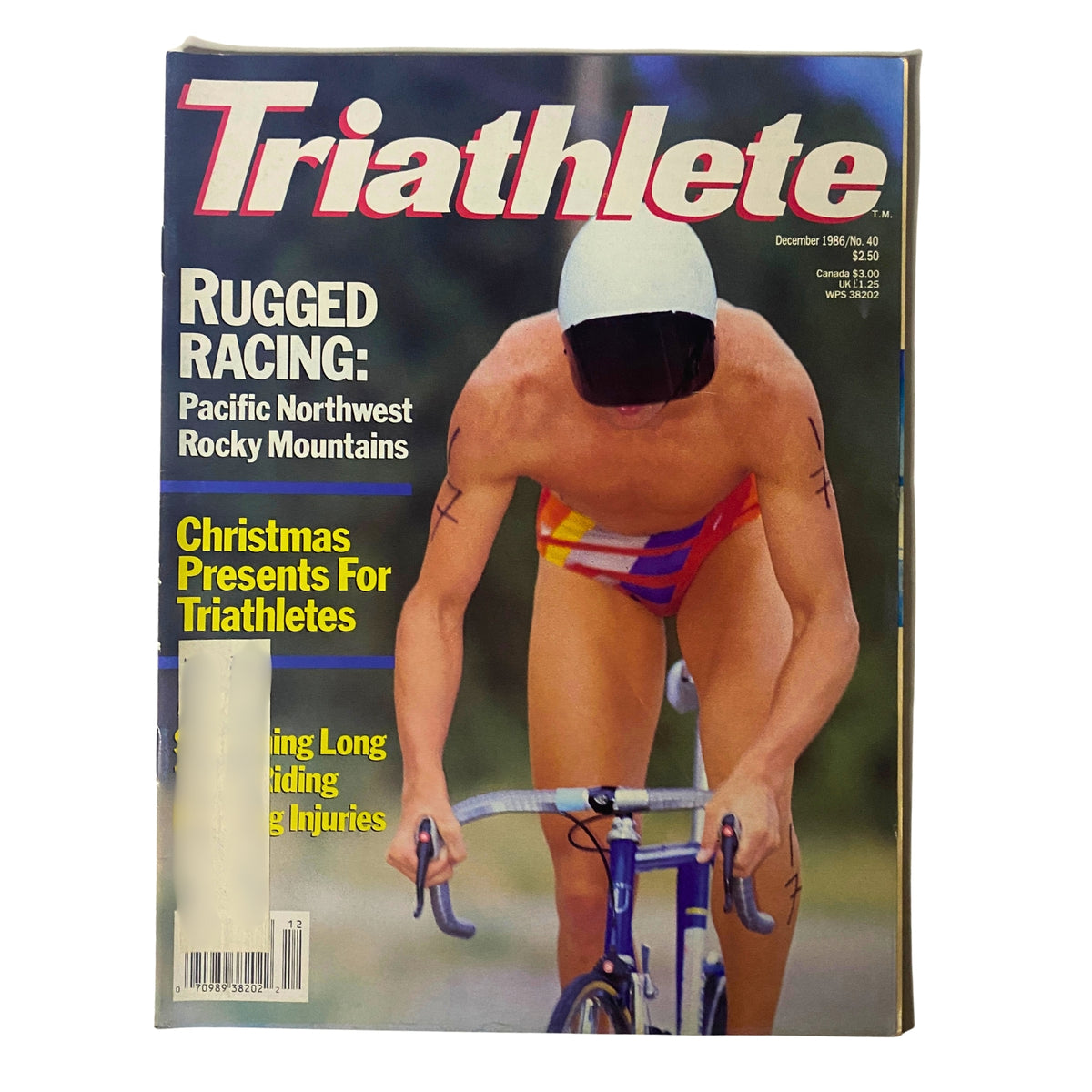 Cover of Triathlete Magazine December 1986 No. 40 featuring athlete in a space-age helmet cycling, highlighting rugged racing in the Pacific Northwest.