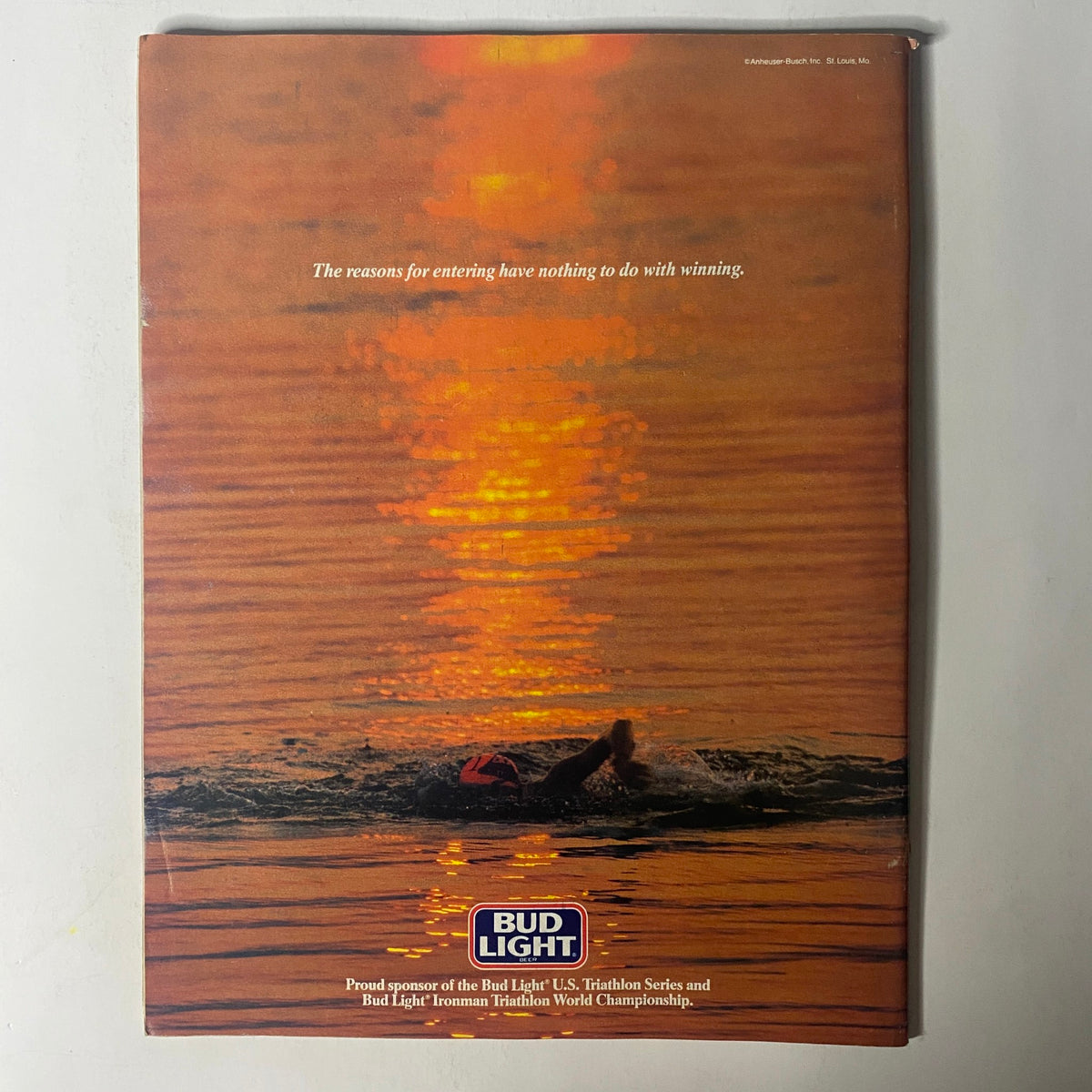 Back cover of Triathlete Magazine June 1987 No. 46, featuring a serene sunset with a swimmer, promoting Bud Light's sponsorship of the triathlon events.
