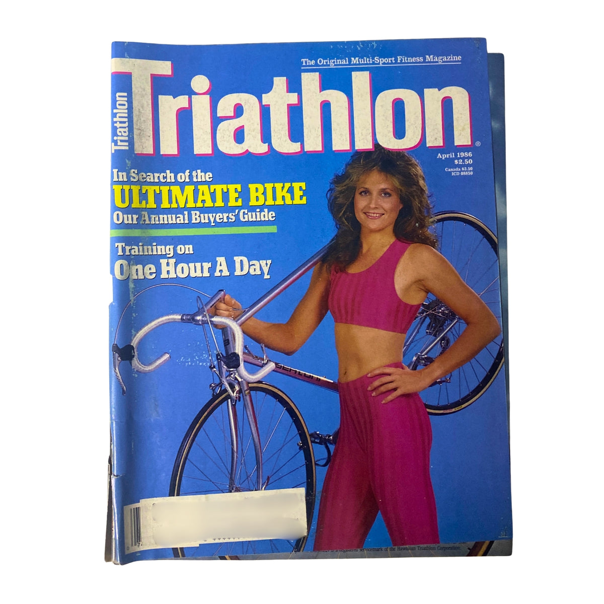 Triathlon Magazine cover from April 1986 featuring Eney Jones, a prominent water swimmer and triathlete from Florida, in a pink athletic outfit with her bicycle. The magazine highlights articles on the ultimate bike, training guides, and triathlon insights.