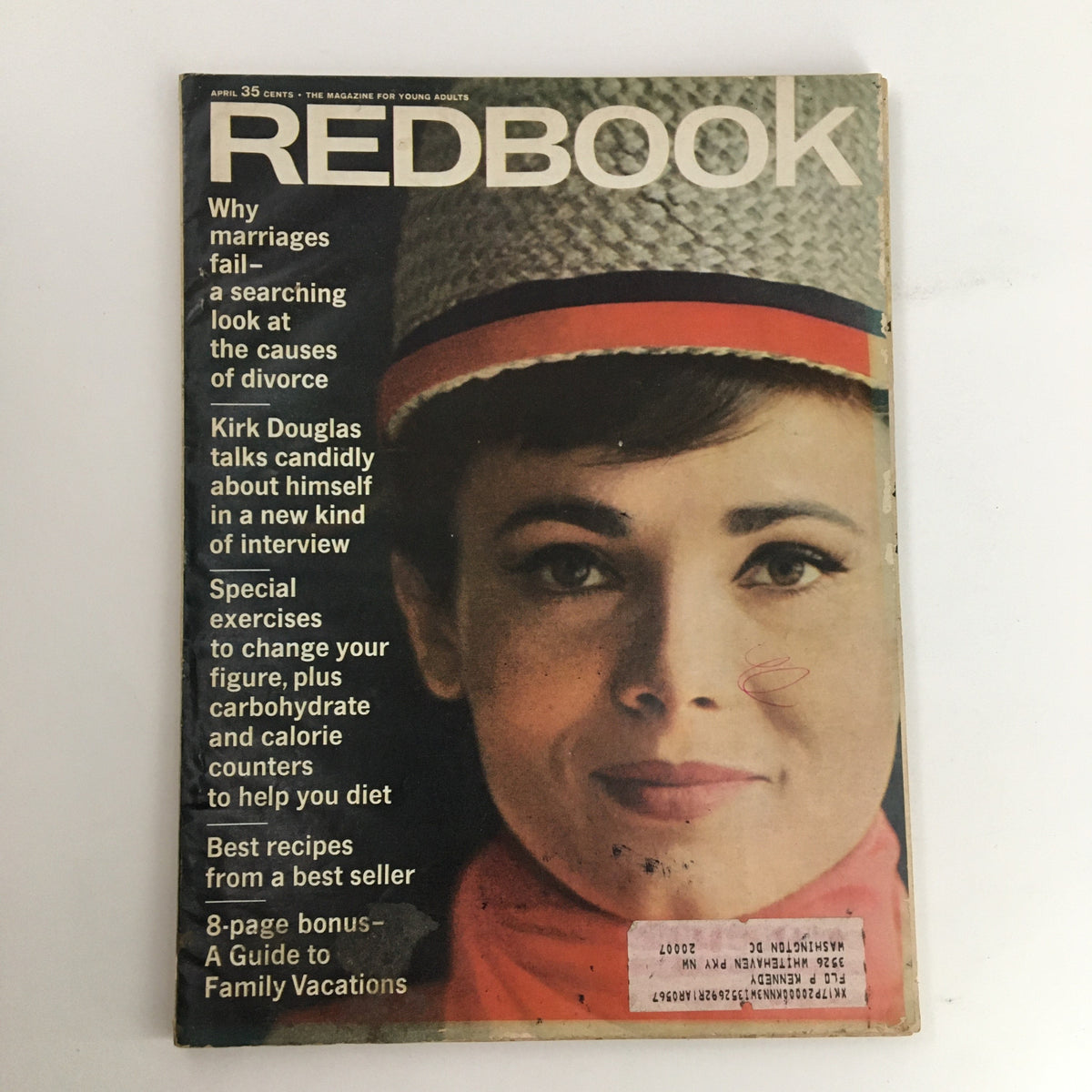 Cover of Redbook Magazine April 1966 featuring the title, Kirk Douglas talks candidly about himself, and a featured model in a hat.