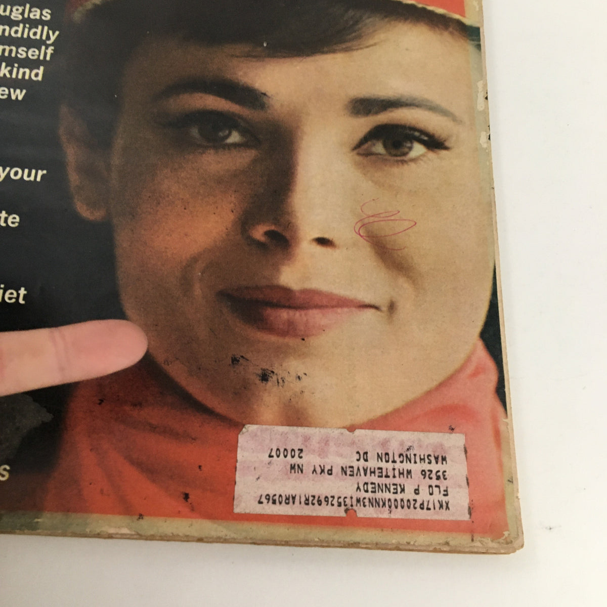 Close-up view of the Redbook Magazine April 1966 cover showing details about Kirk Douglas's candid interview and an address label.