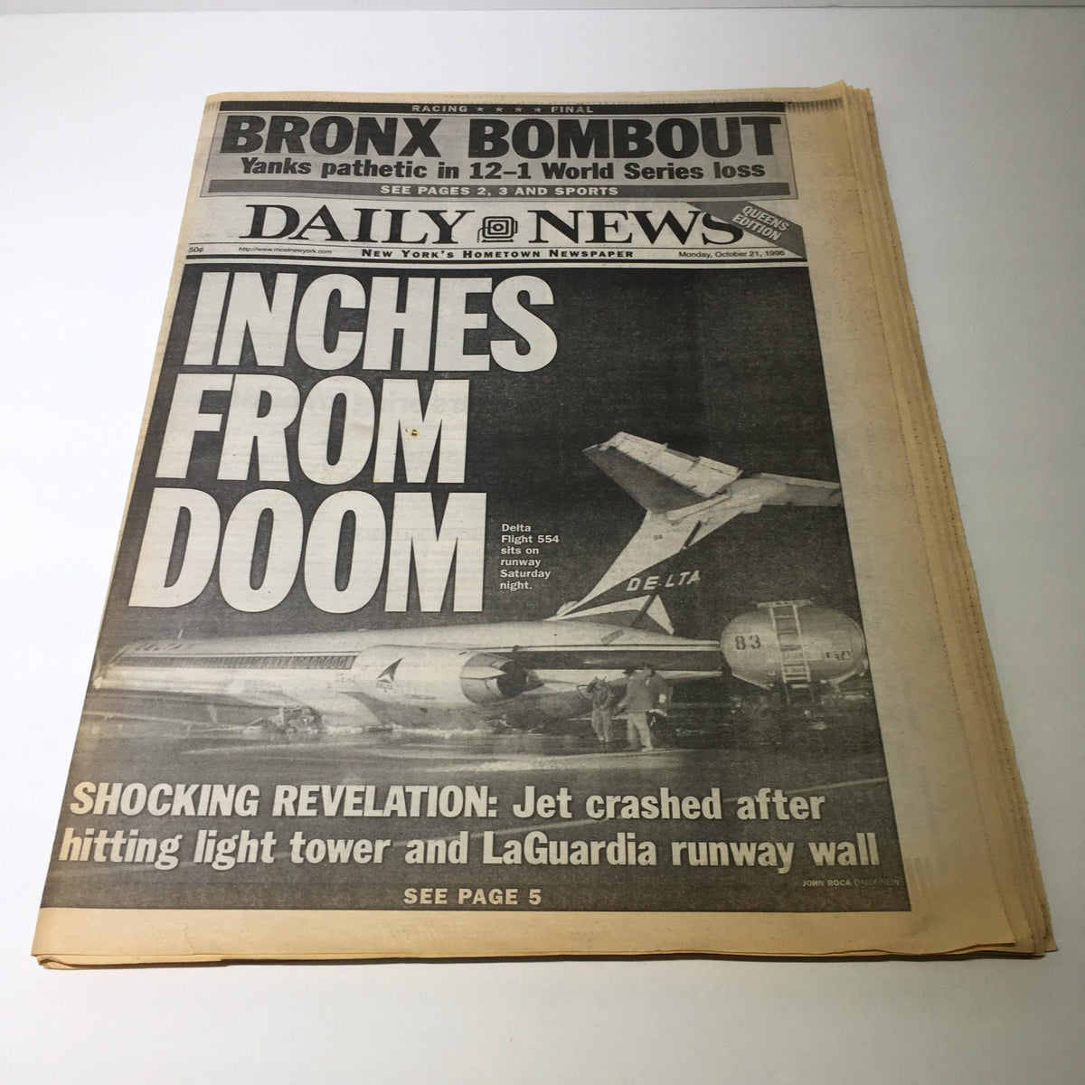 NY Daily News headline from October 21, 1996, titled 'Inches From Doom,' showcasing a historic newspaper featuring an incident involving a jet crash at LaGuardia Airport.
