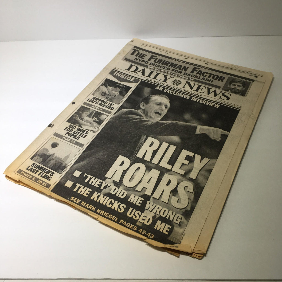 Another vintage newspaper with the headline 'NY Daily News: Sept 3 1995 Riley Roars,' featuring an exclusive interview and commentary on Pat Riley's experience and statements regarding the Knicks.