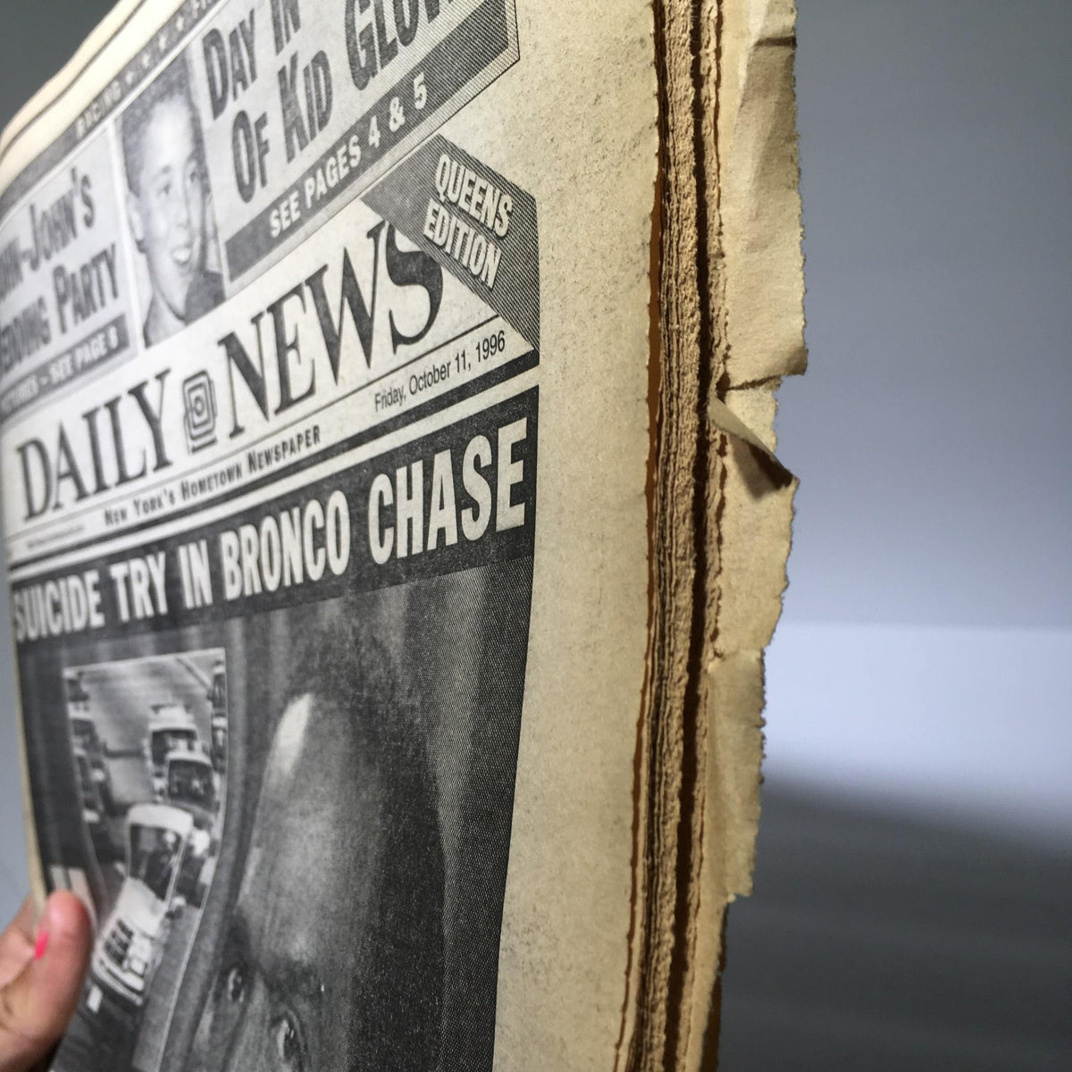 Side view of the NY Daily News from October 11, 1996, depicting the headline 'SUICIDE TRY IN BRONCO CHASE' with slight wear on the edges.
