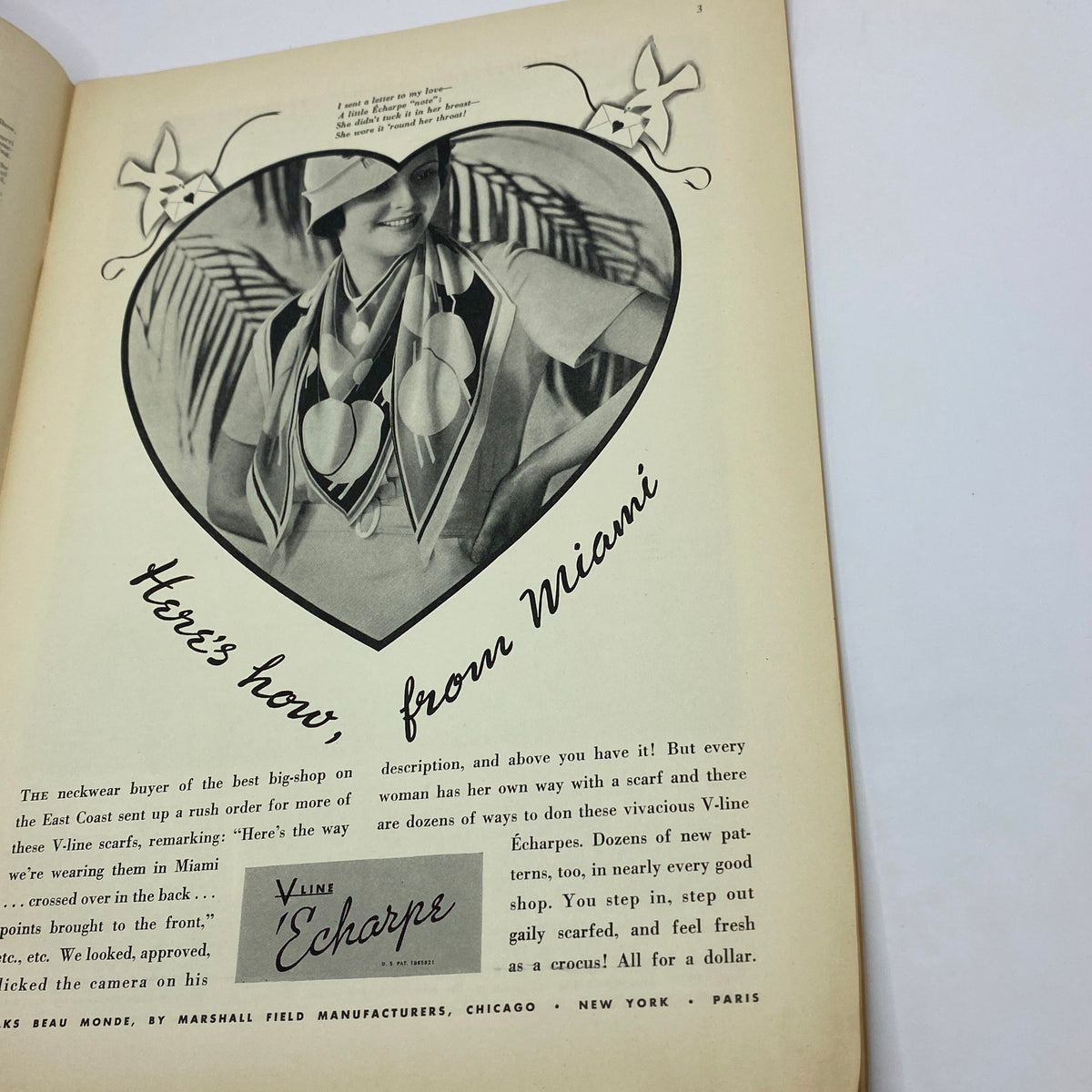 Vintage 1933 advertisement from The New Yorker showcasing a fashionable woman in a heart-shaped frame wearing a stylish scarf, titled 'Here's how from Miami' featuring V-Line Écharpes.