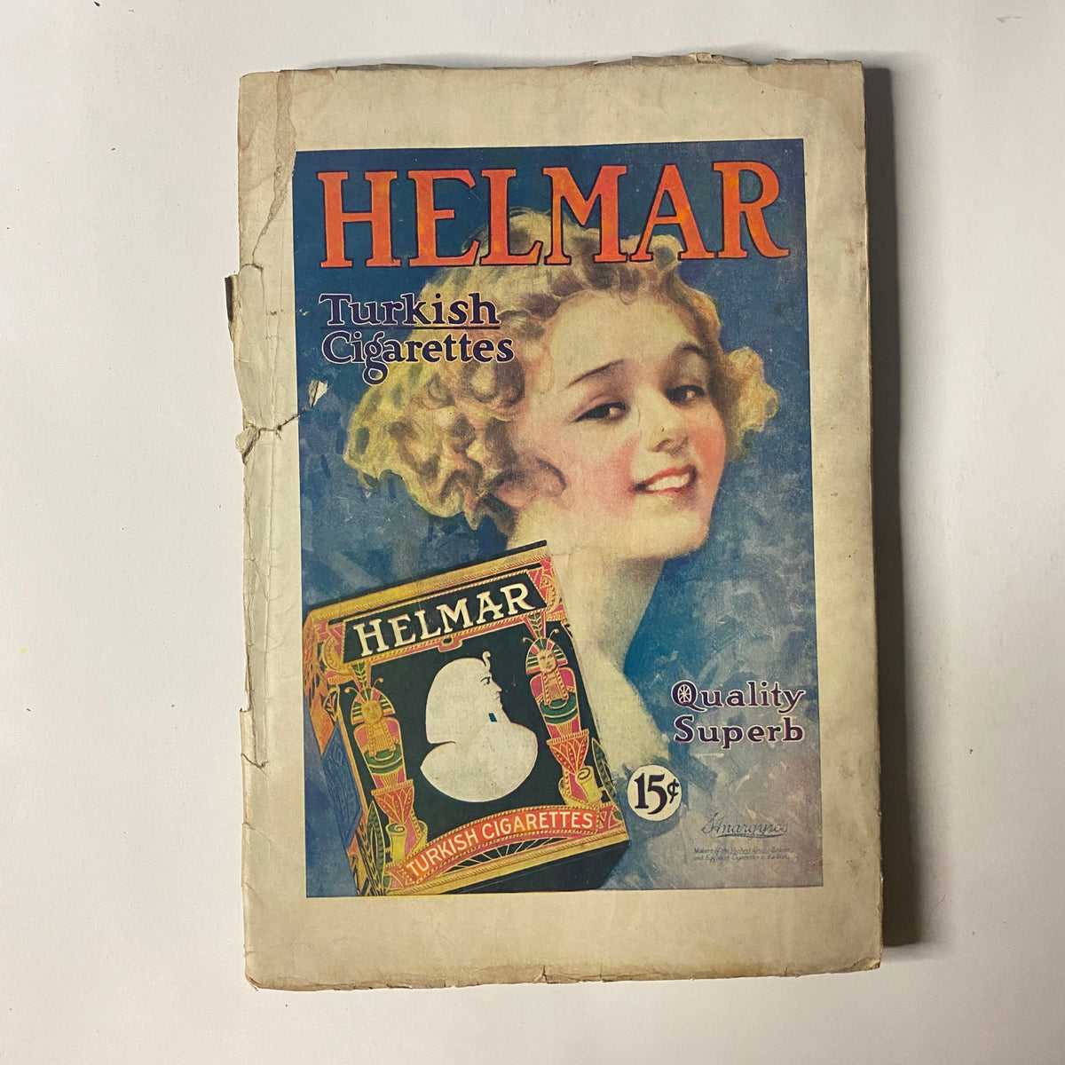 Cover of the Helmar Turkish Cigarettes advertisement, showcasing a vintage illustration of a woman with curly hair and inviting text. This advertisement is likely from the early 20th century, complementing the vintage theme of the People's Favorite Magazine from May 10, 1919.