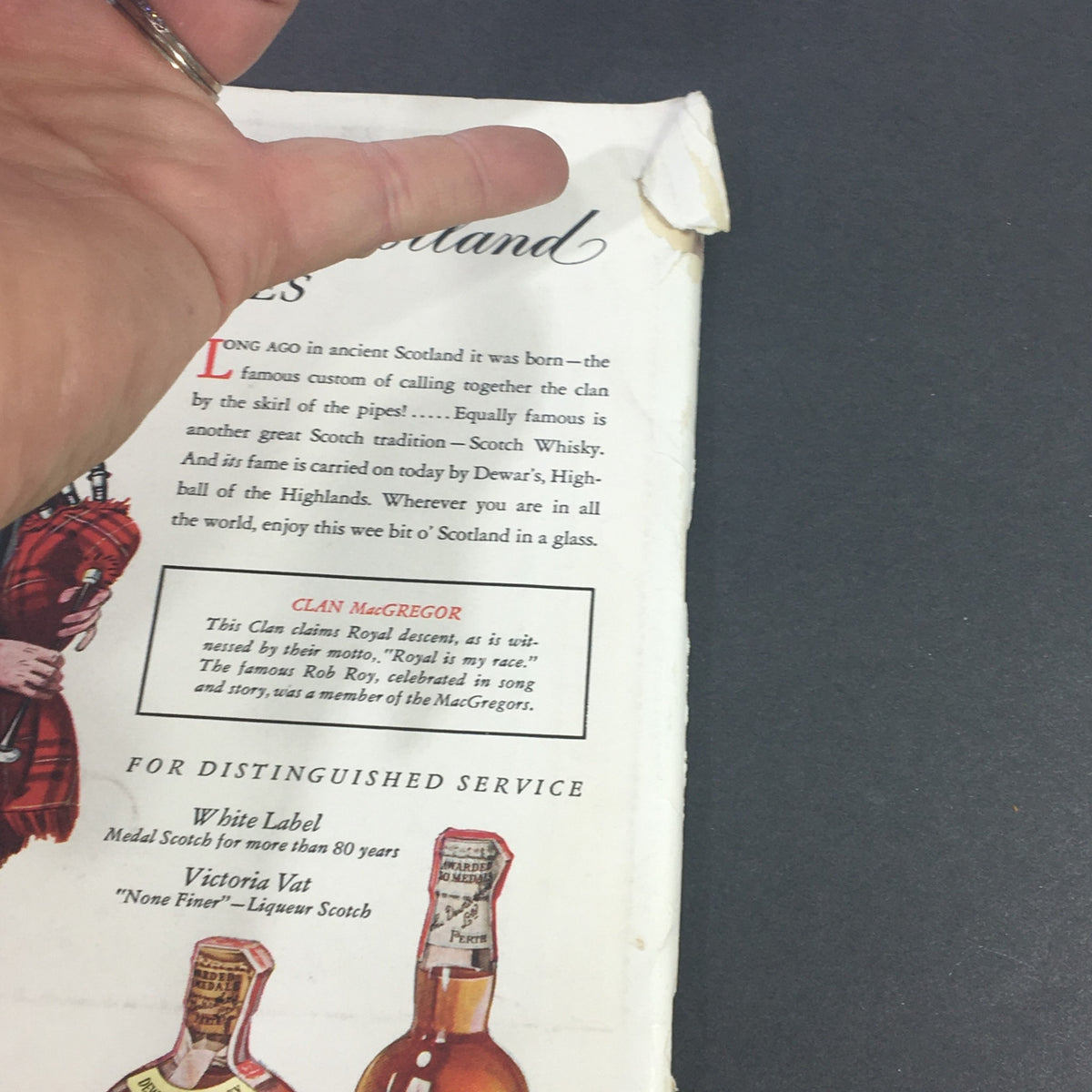 Side view of the back cover of VTG Gourmet The Magazine of Good Living December 1946 highlighting an advertisement for Dewar's Scotch Whisky and a detailed description of Clan MacGregor.
