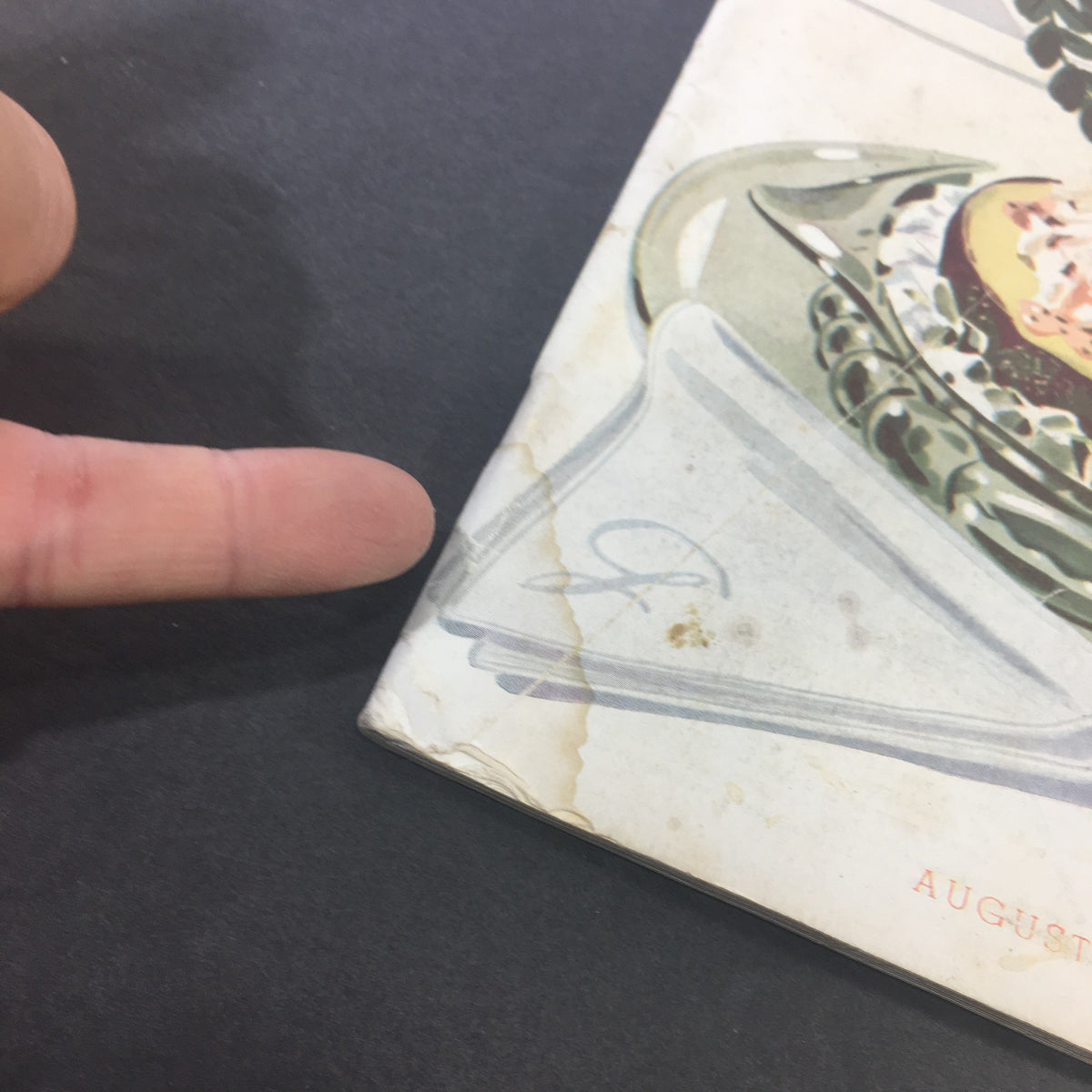 Cover detail of VTG Gourmet Magazine August 1946, showing a vintage illustrated platter with food and a finger pointing to the corner, highlighting condition signs.