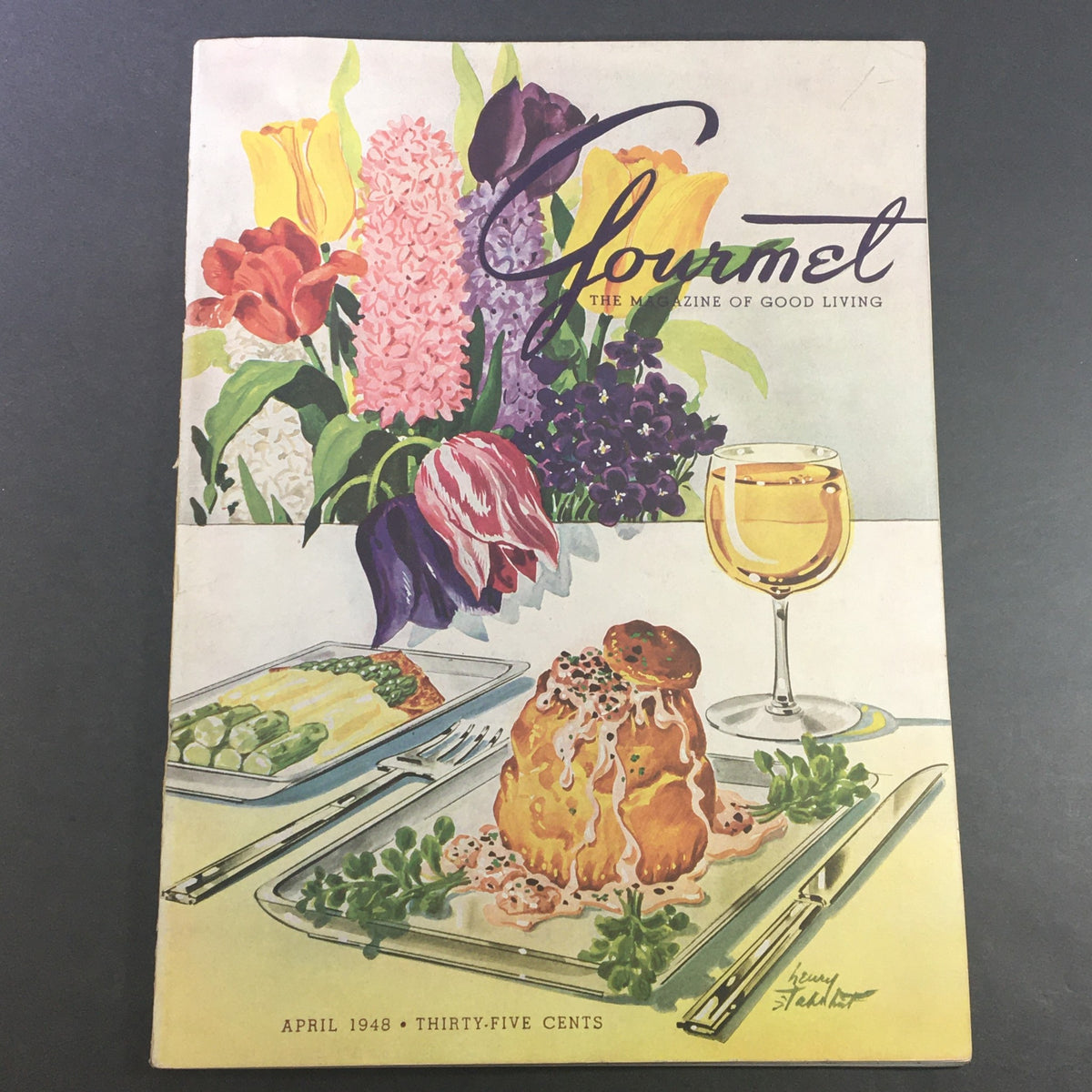 Cover of VTG Gourmet Magazine - April 1948 featuring colorful flowers, a gourmet dish, and a glass of wine, illustrating the theme of 'The Magazine of Good Living'.