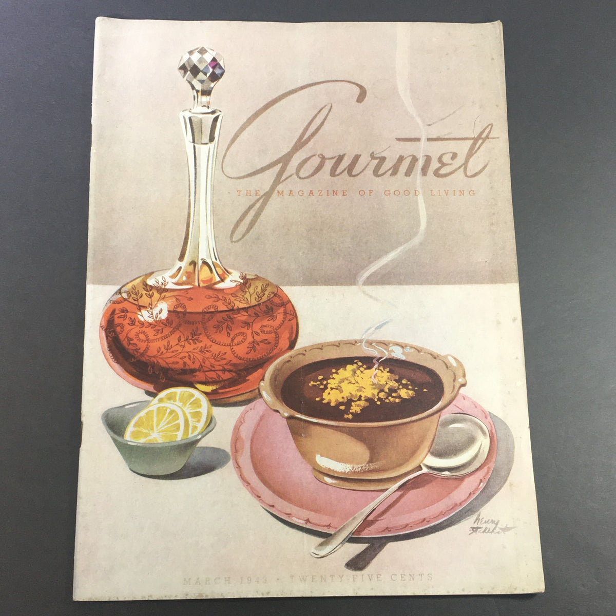 Cover of VTG Gourmet The Magazine of Good Living March 1943 featuring a vintage illustration of a decorative glass decanter and a bowl of soup with lemon slices, promoting the culinary delights of seafood.