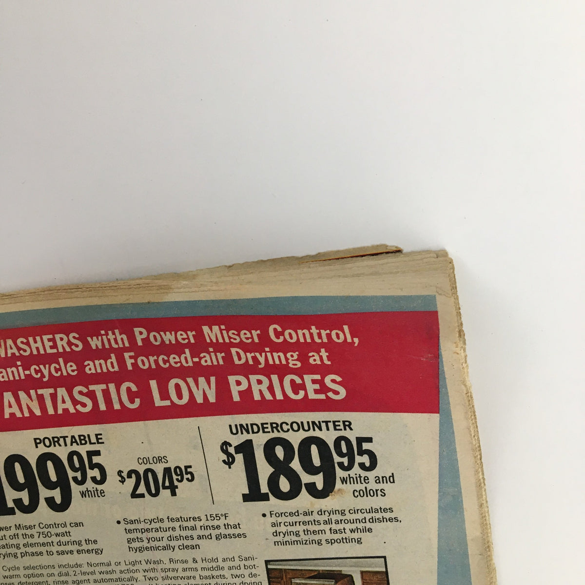 Close-up of the 1976 Sears Roebuck and Co. Midwinter Spectacular Catalog showing dishwasher pricing details with Portable and UnderCounter models.