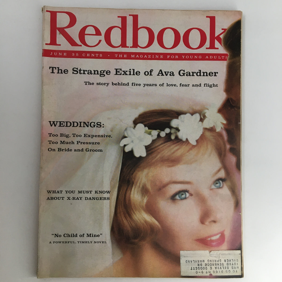 Cover of Redbook Magazine from June 1959 featuring the title 'The Strange Exile of Ava Gardner' with a beautiful model adorned with flowers, capturing the essence of vintage glamour.