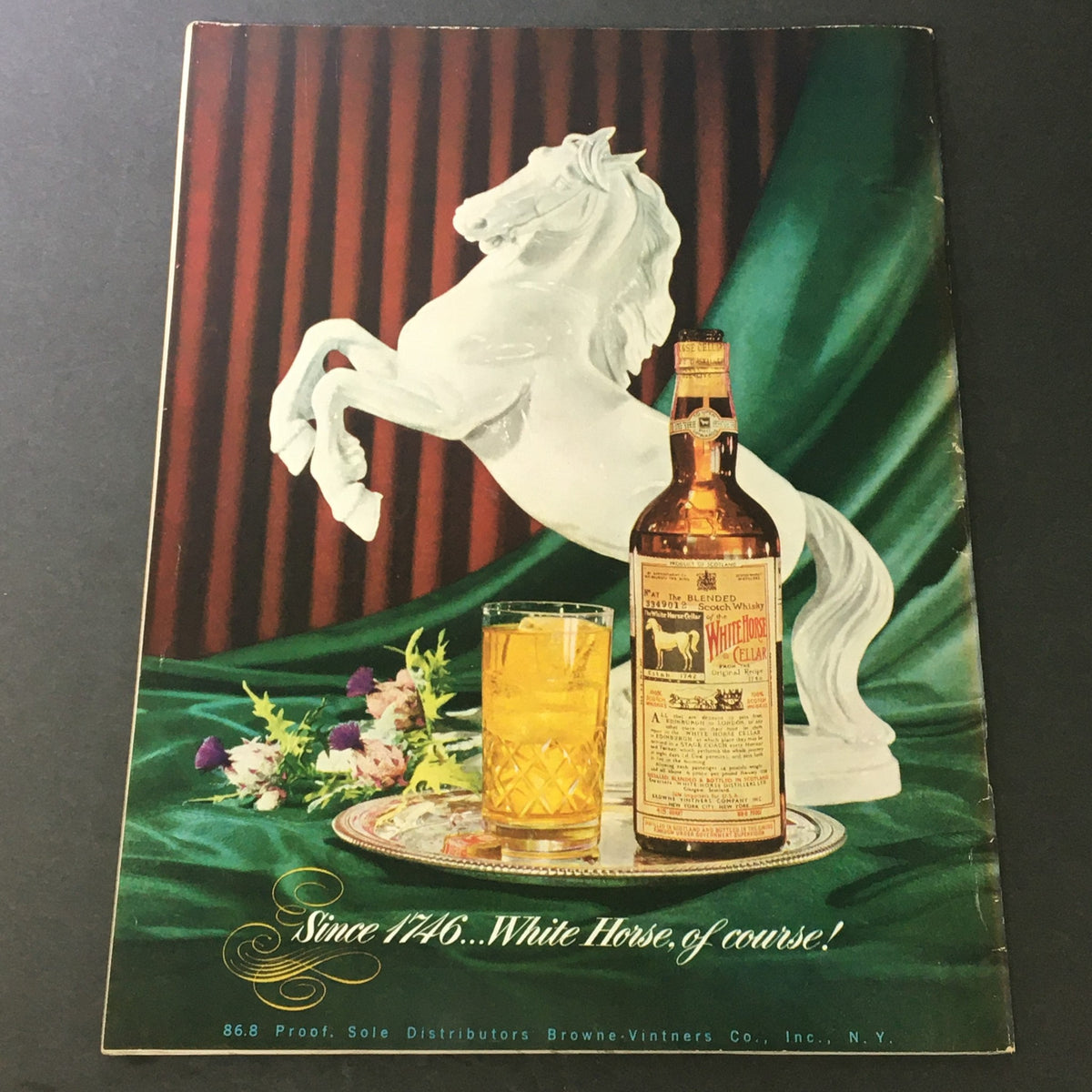 Cover image of VG Gourmet: The Magazine of Good Living from May 1951 featuring a stylized horse sculpture alongside a bottle of White Horse whiskey and a glass of drink, highlighting vintage design and culinary themes.