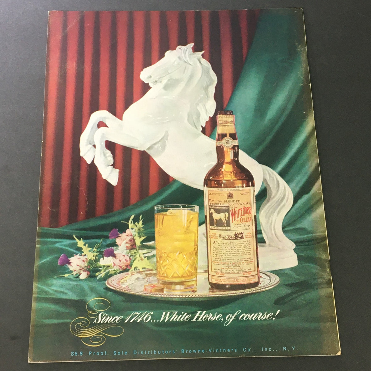 Cover of VTG Gourmet The Magazine of Good Living February 1952, featuring a decorative setup with a white horse statue, a whiskey bottle, and a glass of cocktail on a tray; symbolizing the theme Chef's Holiday, Part II.