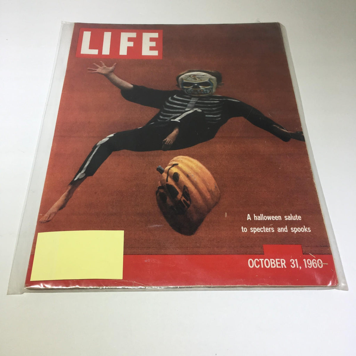 Life Magazine October 31 1960 cover featuring a Halloween theme with a figure in a skeleton outfit and a pumpkin, celebrating specters and spooks.