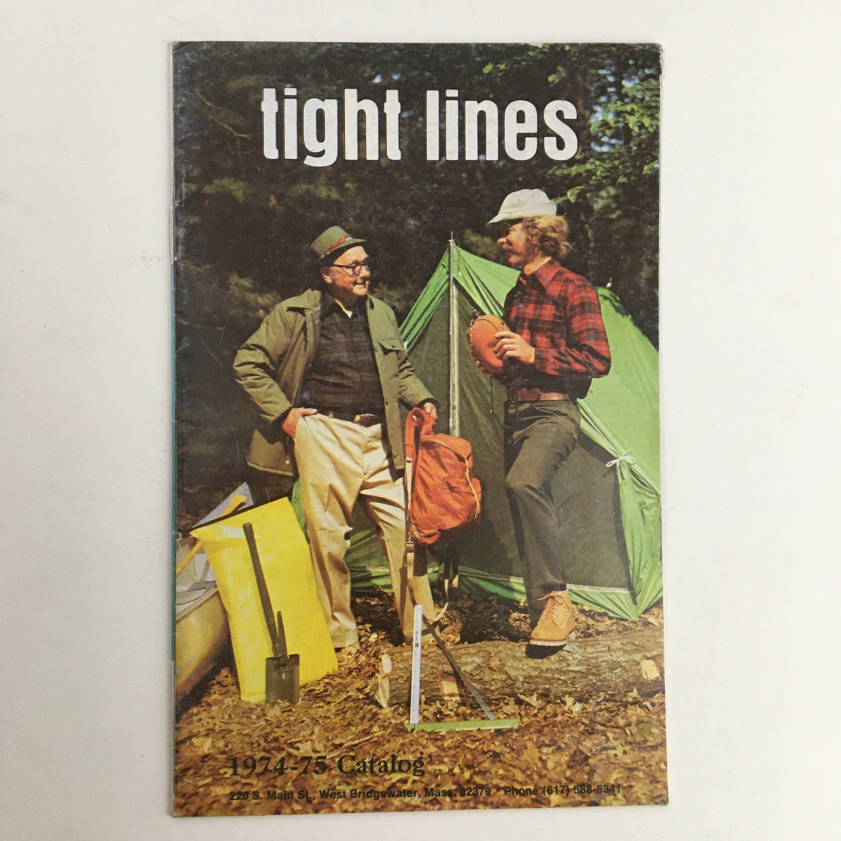 Cover of the 1974 - 1975 Tight Lines Price Guide Catalog featuring two men by a camping site with fishing gear.
