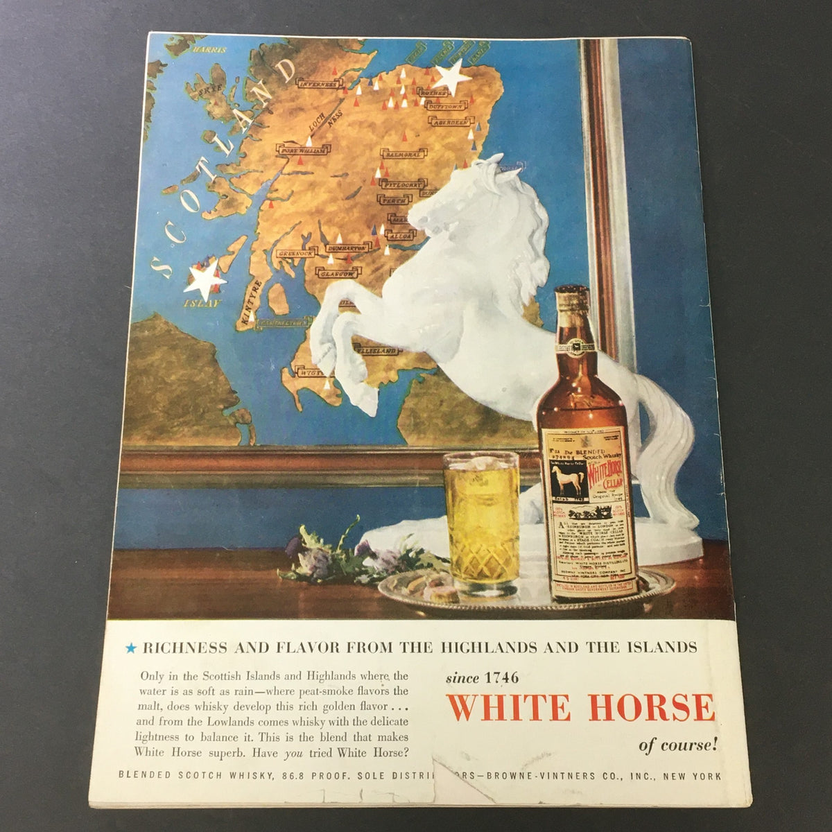 Back cover of VTG Gourmet The Magazine of Good Living, September 1954 edition, showcasing an advertisement for White Horse Scotch Whisky, including a map of Scotland and a bottle with a glass.