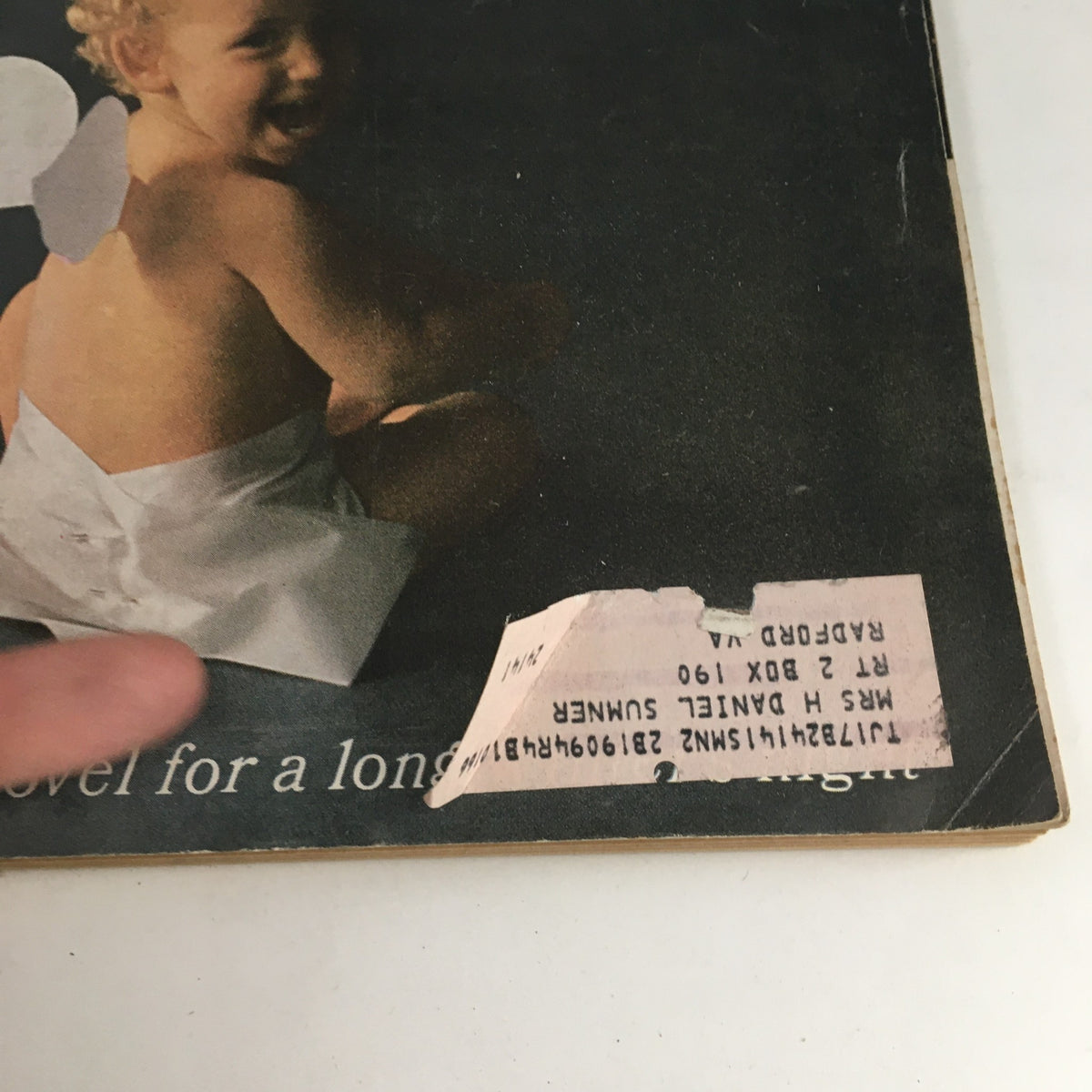 Close-up of the cover of Redbook Magazine December 1965 showing a child in festive attire, with a visible address label, maintaining a vintage appeal.