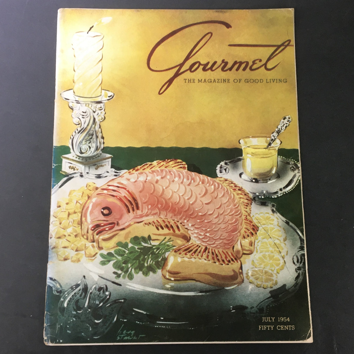 Cover of VTG Gourmet The Magazine of Good Living July 1954 featuring a beautifully illustrated fish dish and a decorative candle, showcasing mid-20th century culinary aesthetics.