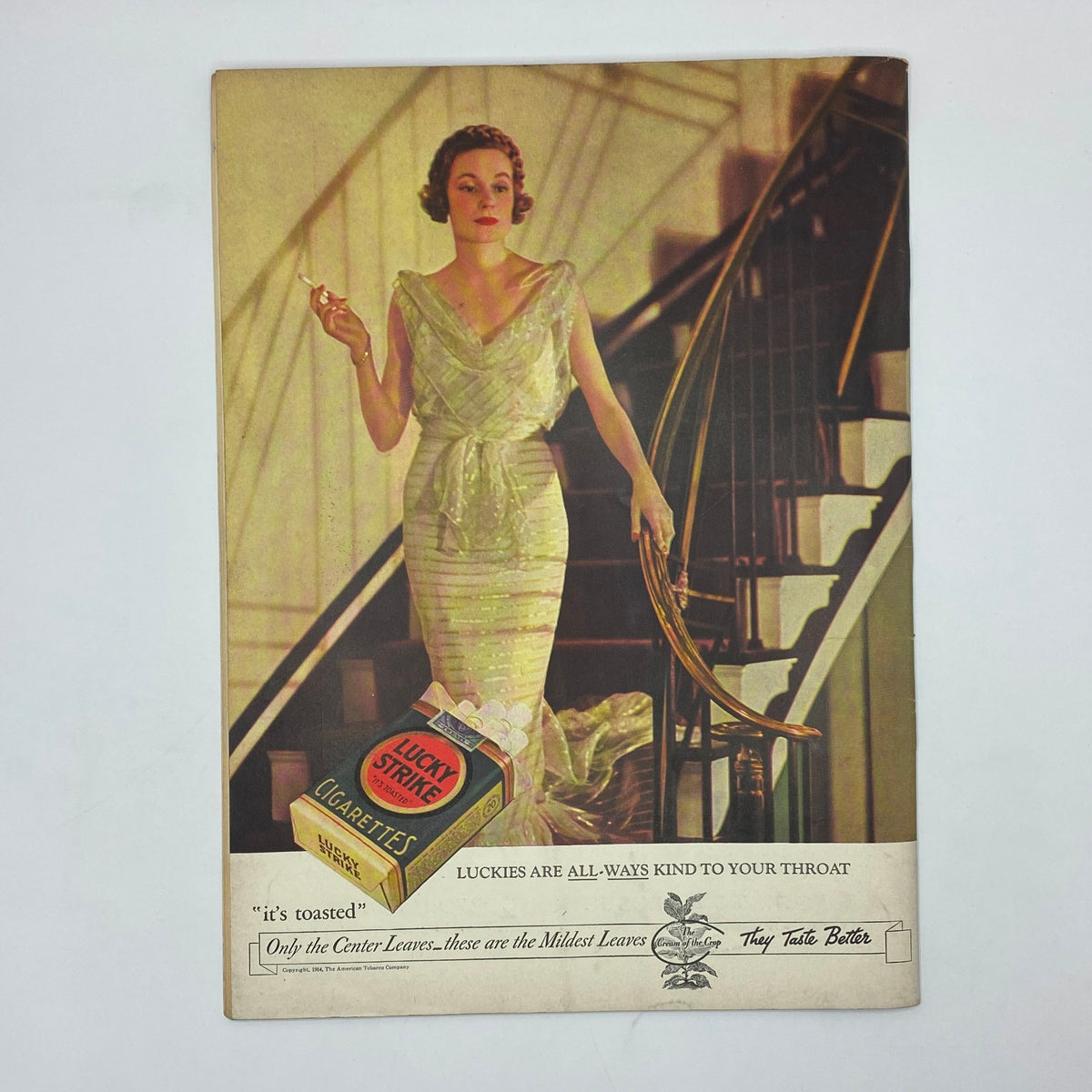 Vintage advertisement for Lucky Strike cigarettes in The New Yorker Complete Magazine July 28, 1934, featuring a woman in a glamorous dress on a staircase.