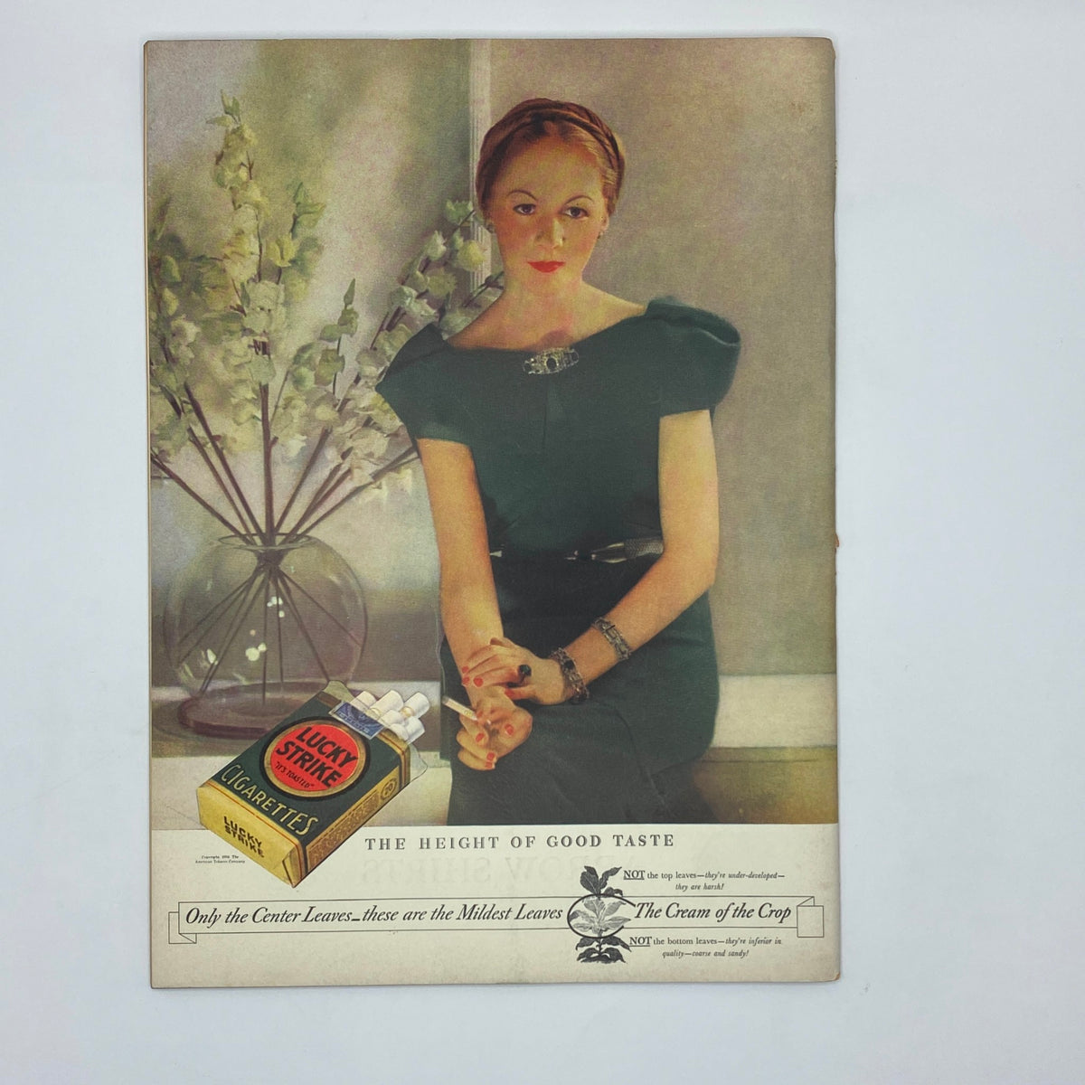 Color advertisement page from The New Yorker magazine April 28, 1934 featuring a model in a stylish green dress sitting beside a vase of flowers, advertising Lucky Strike cigarettes, included in the issue with Ilonka Karasz's cover.
