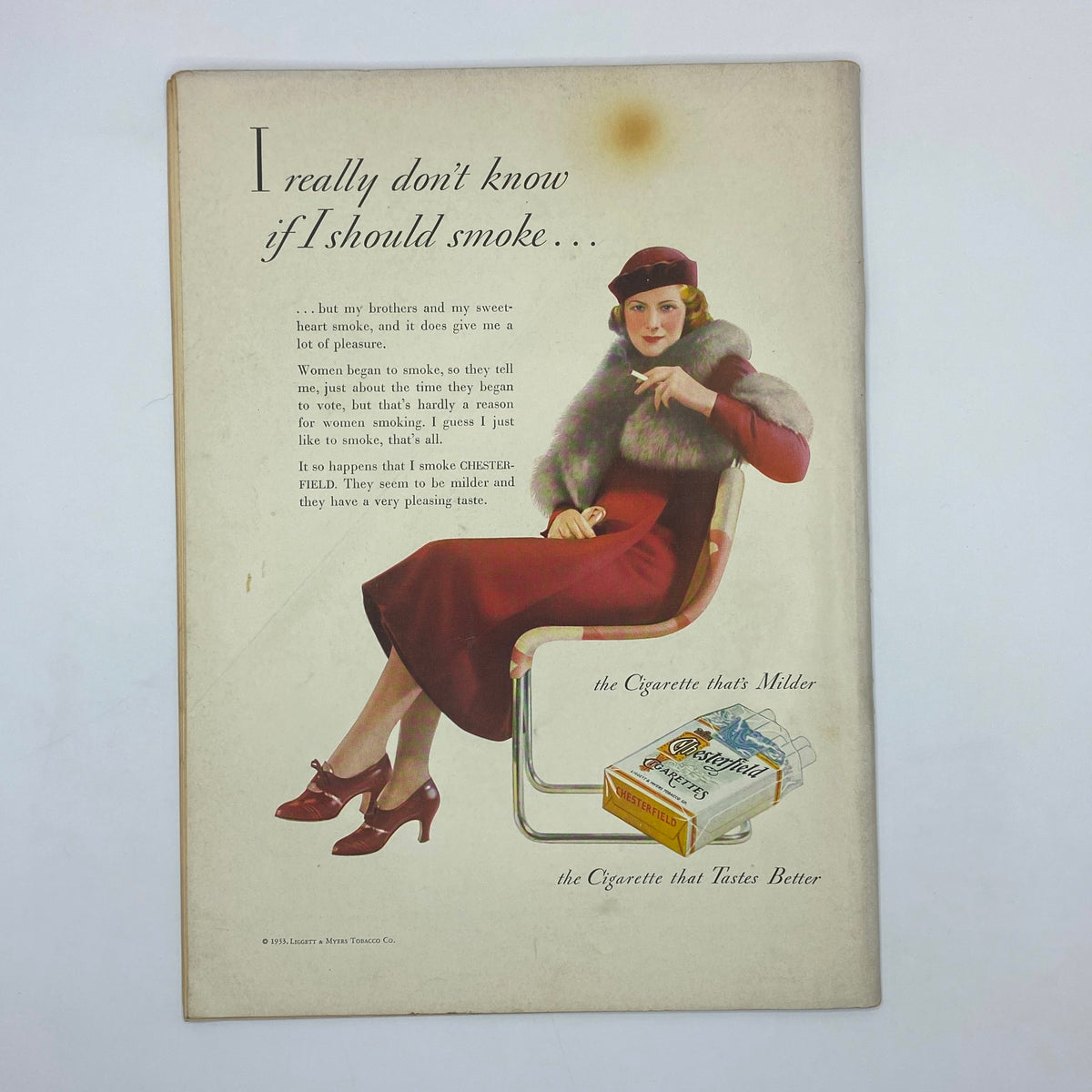 Vintage advertisement from The New Yorker magazine January 14, 1933, featuring a woman contemplating smoking, promoting Chesterfield cigarettes with elegant imagery and text.