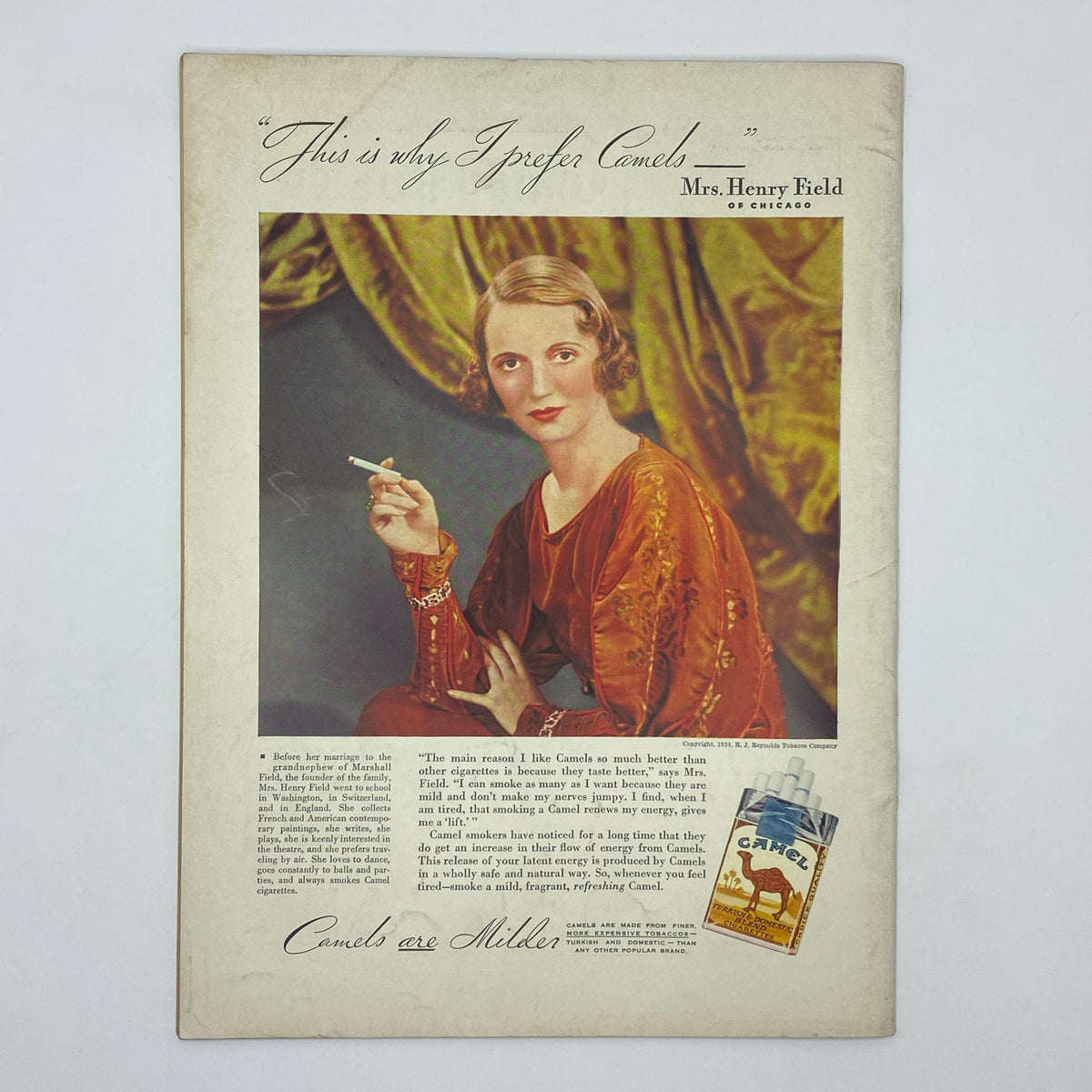 Vintage advertisement featuring Mrs. Henry Field of Chicago promoting Camel cigarettes, illustrating her preference for the brand with an elegant pose and a cigarette in hand. The ad includes the quote, 'This is why I prefer Camels,' alongside a cigarette pack, all set against an ornate backdrop, capturing the advertising style of the early 20th century.
