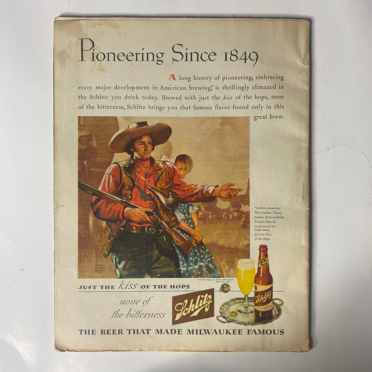 Back cover of Radio Mirror Magazine February 1944 featuring an advertisement for Schlitz beer, illustrating the theme of pioneering in brewing with imagery of a cowboy and a refreshing drink.