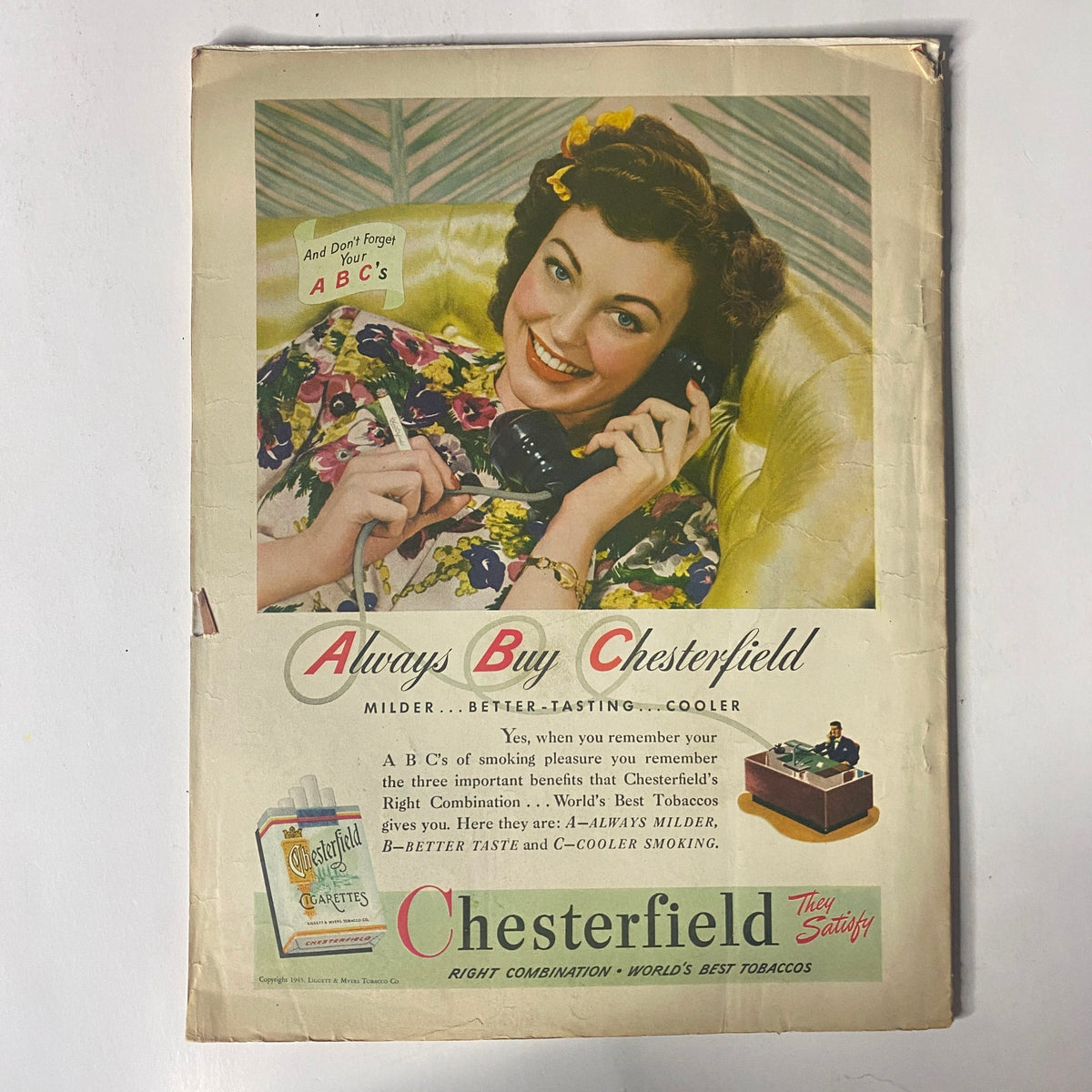 An advertising page for Chesterfield cigarettes from Radio Romances Magazine, October 1945, showcasing a smiling woman promoting the brand with a colorful portrait, reflecting the marketing style of the 1940s.