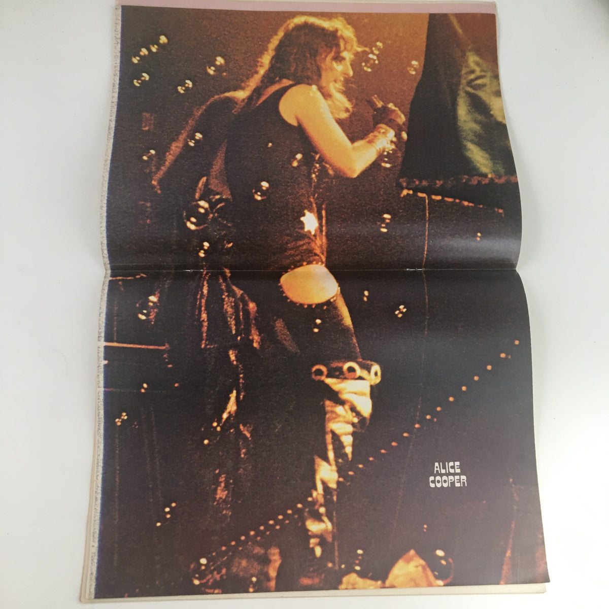 Alice Cooper performing live, featured in Hit Parader Magazine May 1973 No. 106, showcasing the rock icon's dramatic stage presence.