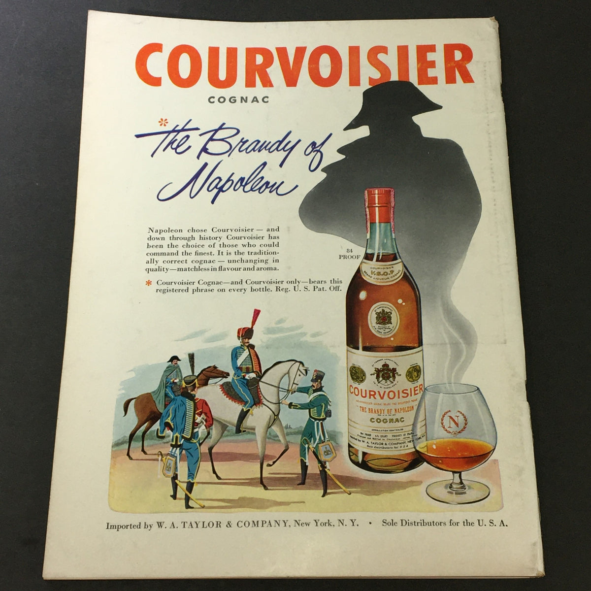 Vintage advertisement for Courvoisier Cognac, from December 1951 issue of VTG Gourmet: The Magazine of Good Living, showcasing a bottle and historical-themed illustration.