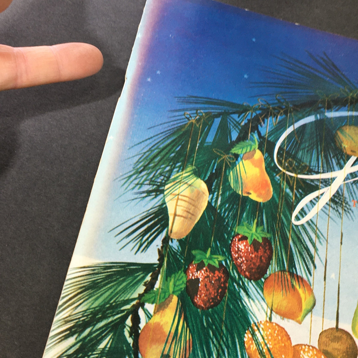 Close-up of the vintage cover of VTG Gourmet: The Magazine of Good Living, December 1952, highlighting decorative fruits and greenery in a Christmas theme.
