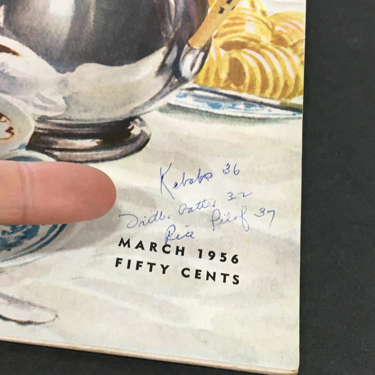 Close-up of handwritten notes on the cover of VTG Gourmet The Magazine of Good Living March 1956, adding a personal historical touch to the vintage publication.