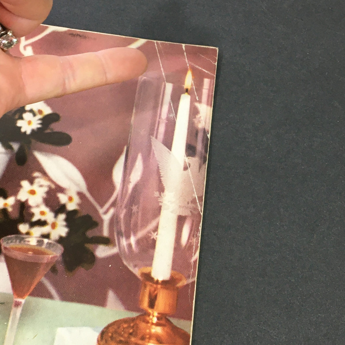 Close-up of VTG Gourmet The Magazine of Good Living June 1957 cover showing a candle holder and drinks, illustrating the vintage elegance of the 1950s.