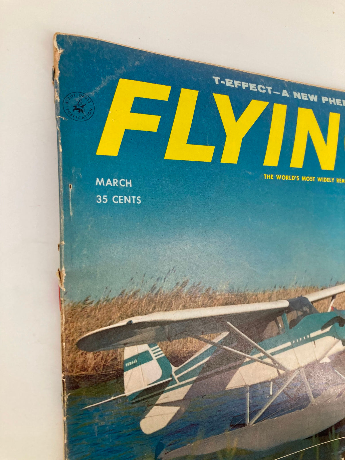 Side view of the VTG Flying Magazine March 1958, capturing the title and image of the Tri-Pacer 160, with some wear at the edges, indicative of its age.
