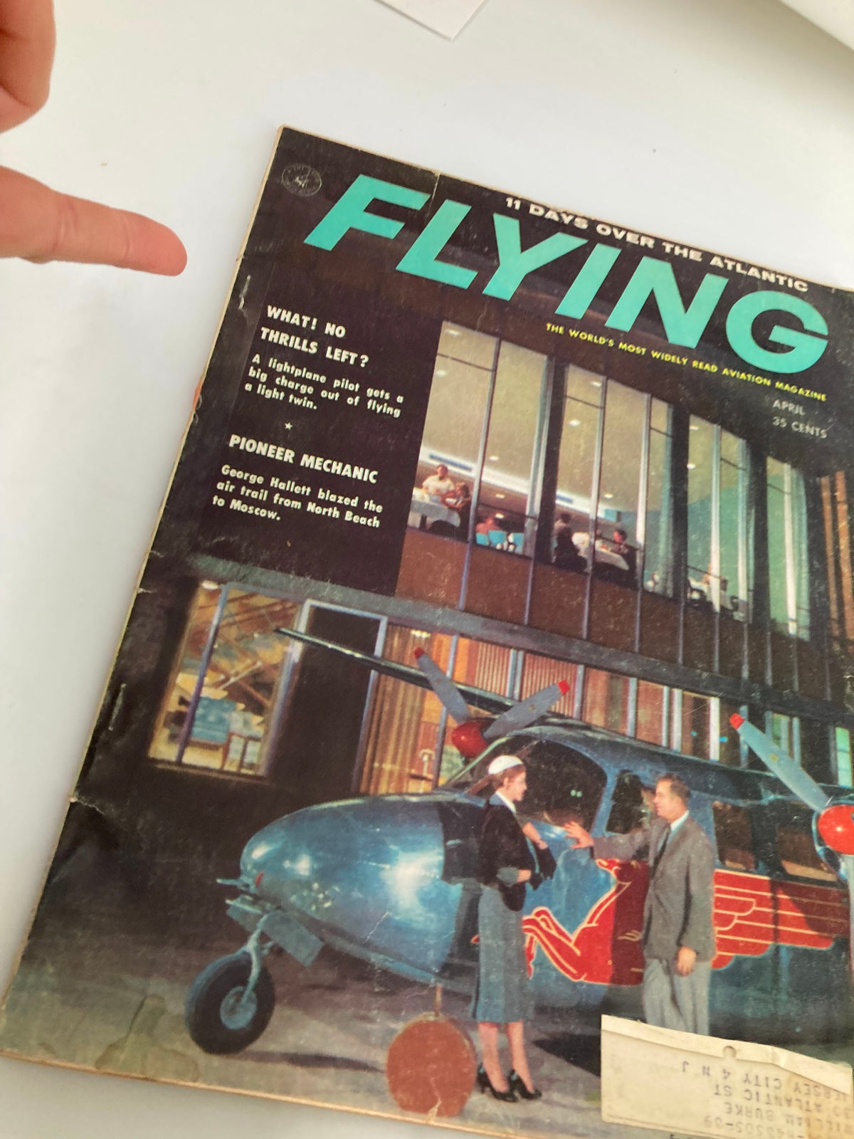 Cover of VTG Flying Magazine April 1958 featuring the title in bold letters and a photo of George Hallett with a vintage aircraft at North Beach.
