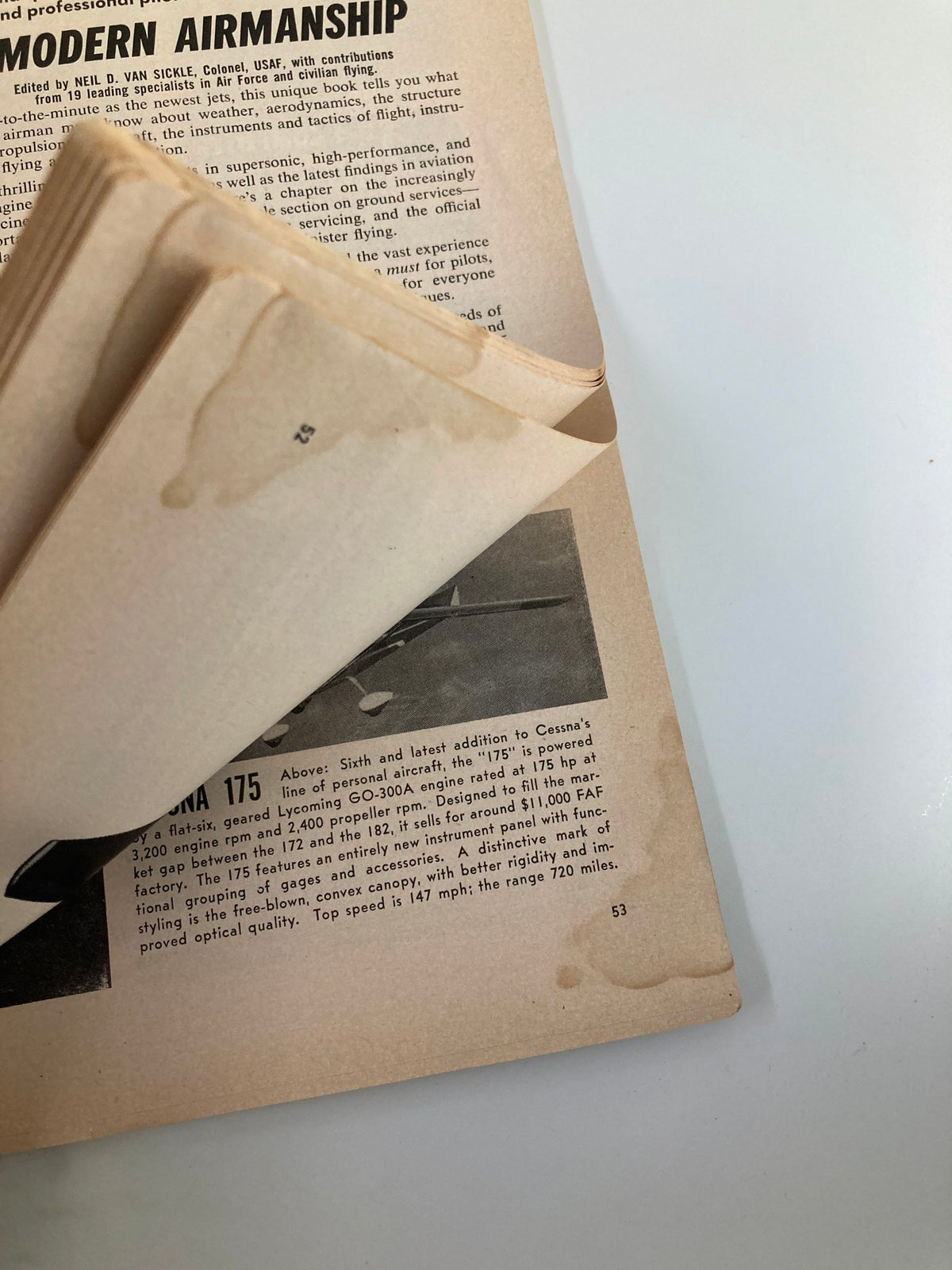 Detailed glimpse of another page in the VTG Flying Magazine April 1958, showcasing information about the Cessna 175 along with minor wear marks indicative of its vintage nature.