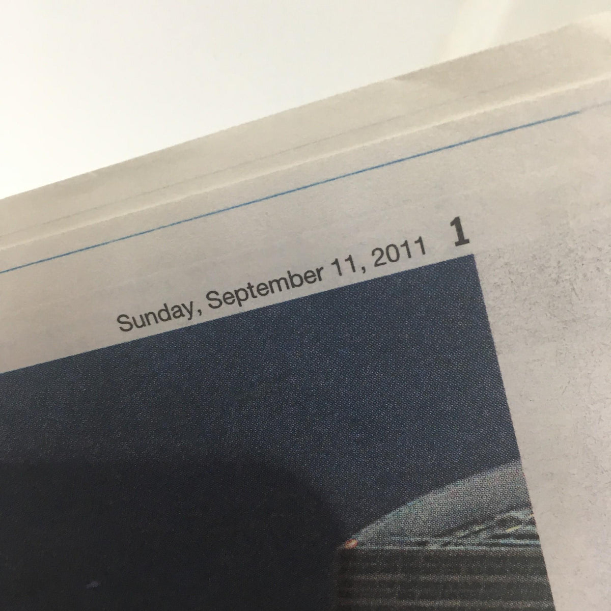 Close-up of the date on the New York Daily News magazine, featuring 'Sunday, September 11, 2011', commemorating the tenth anniversary of the 9/11 attacks.